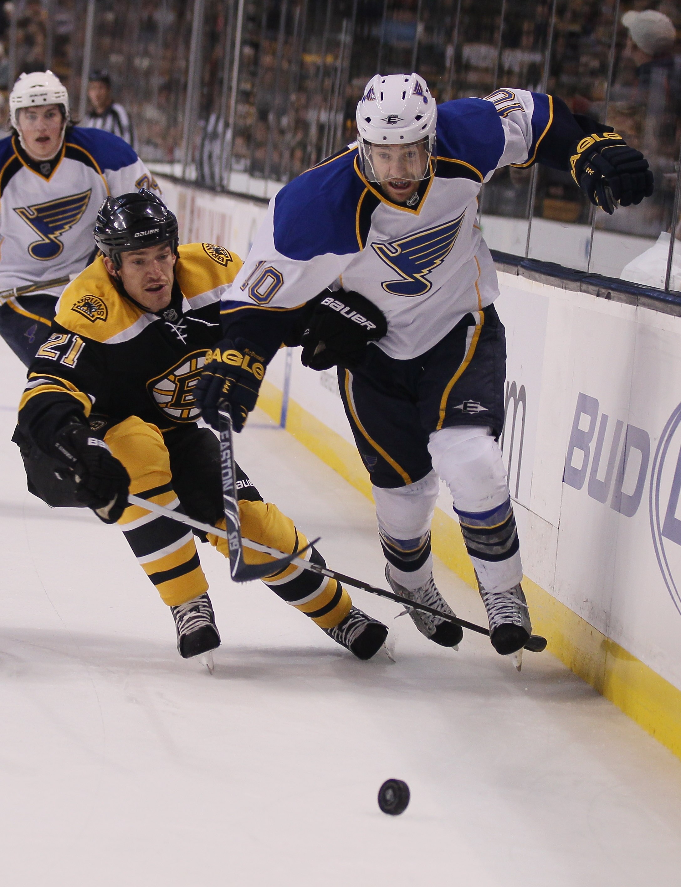 BOSTON - NOVEMBER 06:  Andrew Ference #21 of the Boston Bruins and Andy McDonald #10 of the St. Louis Blues battle for the puck on November 6, 2010 at the TD Garden in Boston, Massachusetts. The Blues defeated the Bruins 2-1 in an overtime shootout.  (Pho