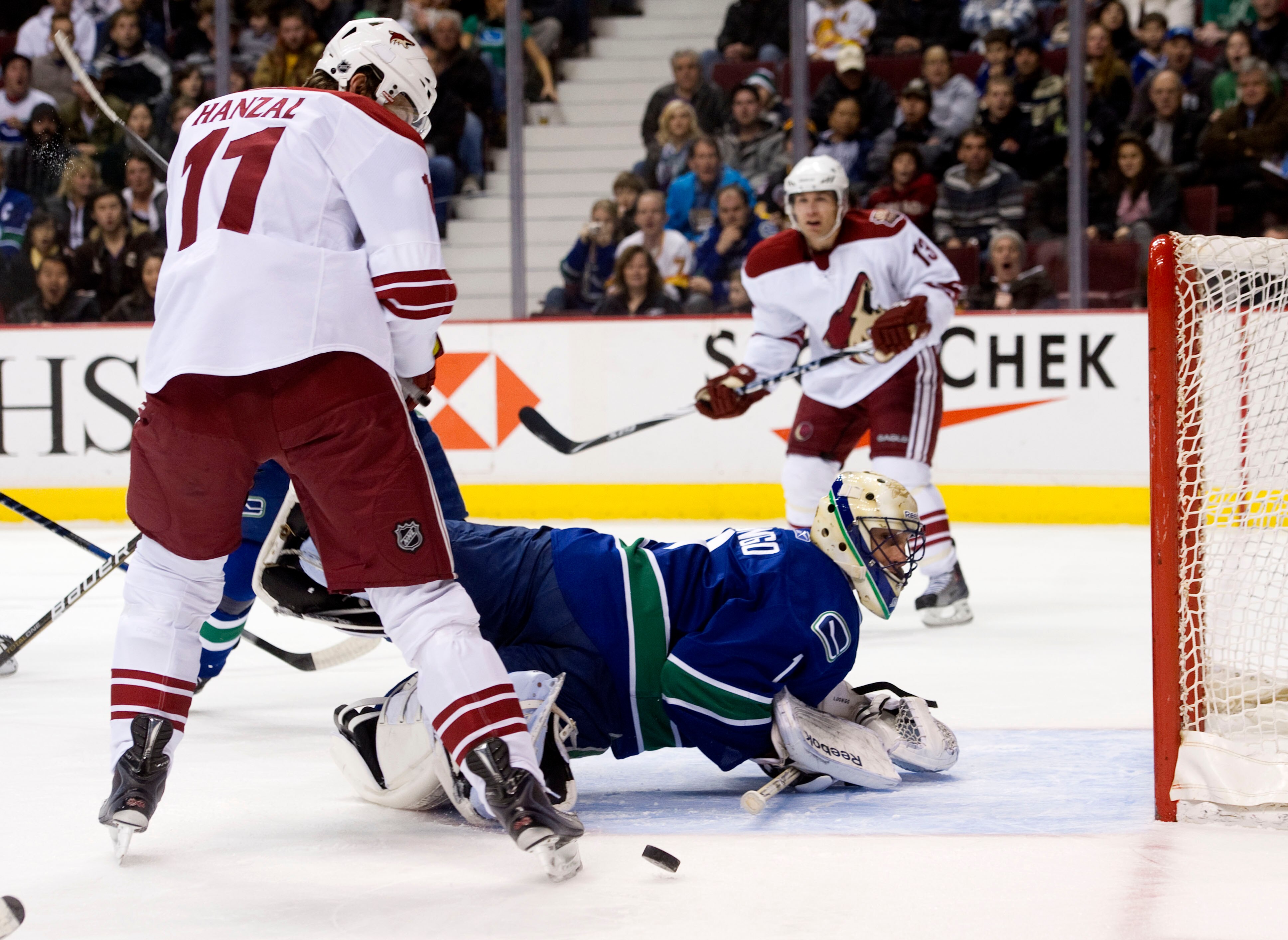 VANCOUVER, CANADA - NOVEMBER 21: Goalie Roberto Luongo #1 of the Vancouver Canucks looses sight on the puck after a shot by Ray Whitney #13of the Phoenix Coyotes hits the post during the first period in NHL action on November 21, 2010 at Rogers Arena in V