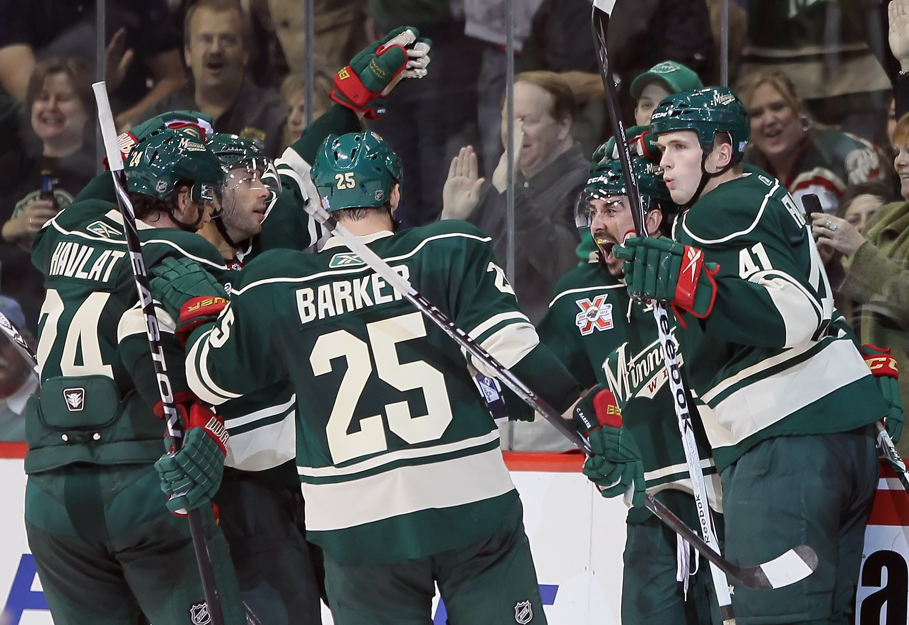ST PAUL, MN - OCTOBER 16:  (L-R) Martin Havlat #24, Matt Cullen #7, Cam Barker #25, Cal Clutterbuck #22 and Justin Falk #41 of the Minnesota Wild celebrate Clutterbuck's second period goal against the Columbus Blue Jackets at Xcel Energy Center on October