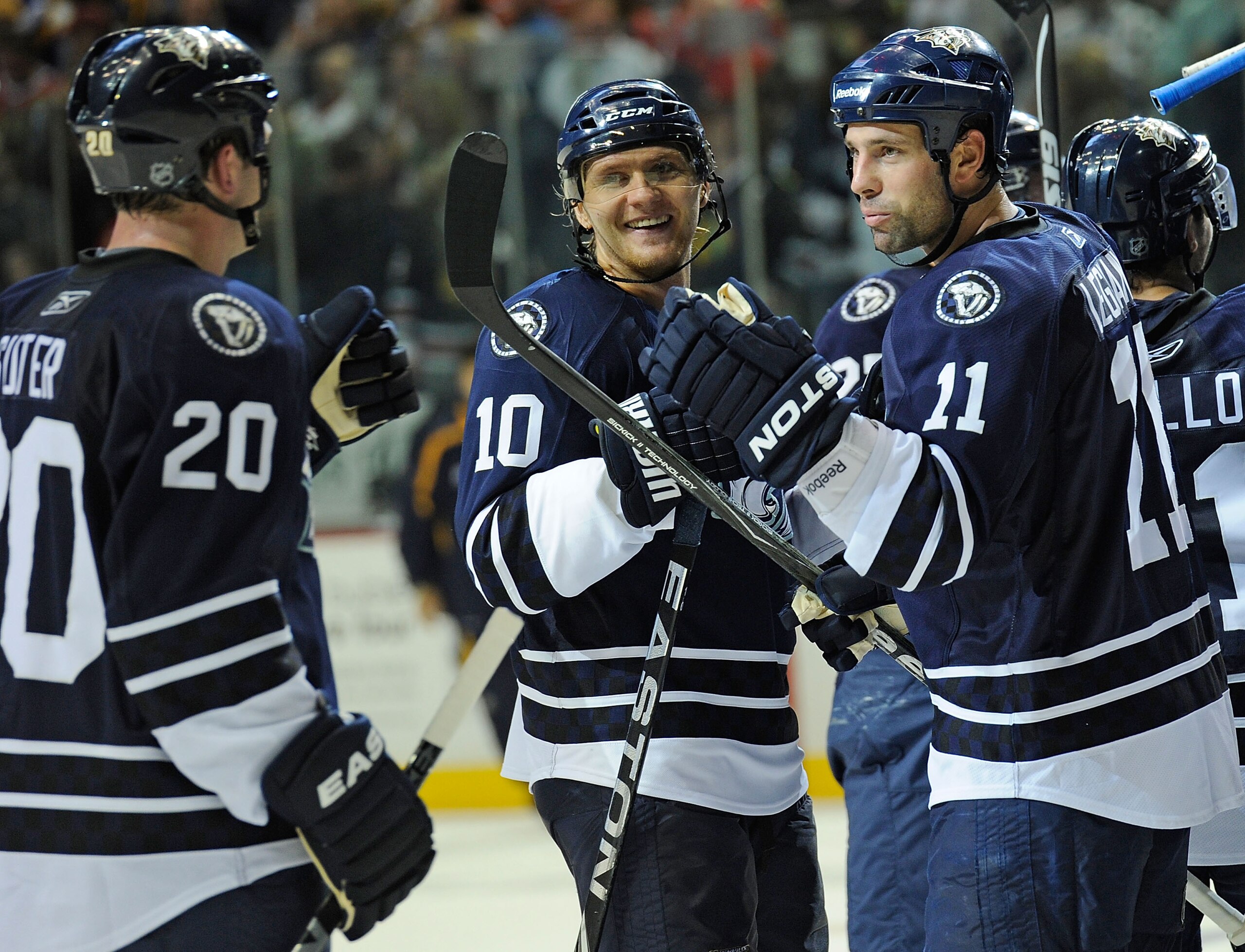 NASHVILLE, TN - NOVEMBER 13:  Ryan Suter #20, Martin Erat #10, and David Legwand #11 of the Nashville Predators celebrate after a shootout win against the Chicago Blackhawks at the Bridgestone Arena on November 13, 2010 in Nashville, Tennessee.  (Photo by