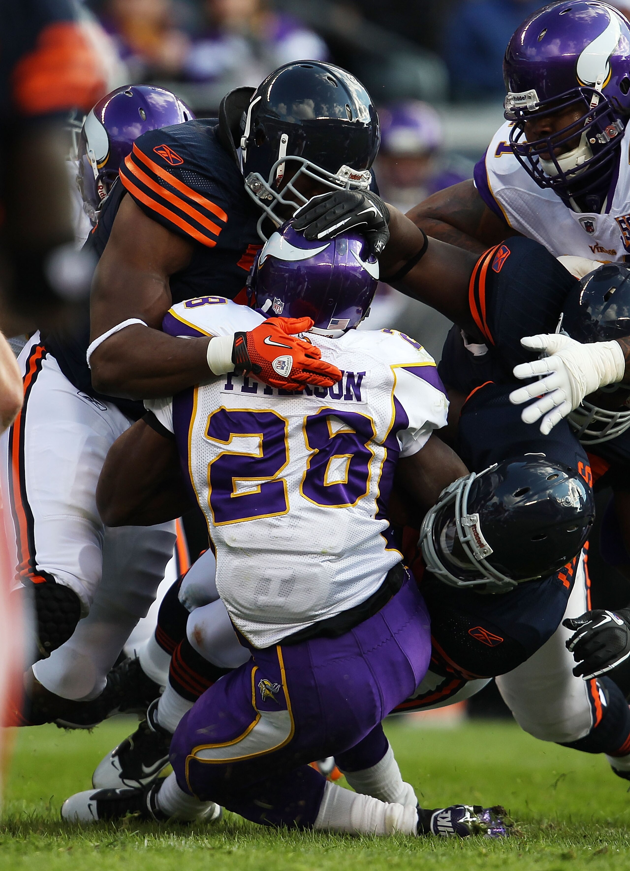 CHICAGO - NOVEMBER 14: Adrian Peterson #28 of the Minnesota Vikings is tackled by members of the Chicago Bear defense including Israel Idonije #71 (L) and Chris Harris #46 at Soldier Field on November 14, 2010 in Chicago, Illinois. The Bears defeated the CHICAGO - NOVEMBER 14: Adrian Peterson #28 of the Minnesota Vikings is tackled by members of the Chicago Bear defense including Israel Idonije #71 (L) and Chris Harris #46 at Soldier Field on November 14, 2010 in Chicago, Illinois. The Bears defeated the