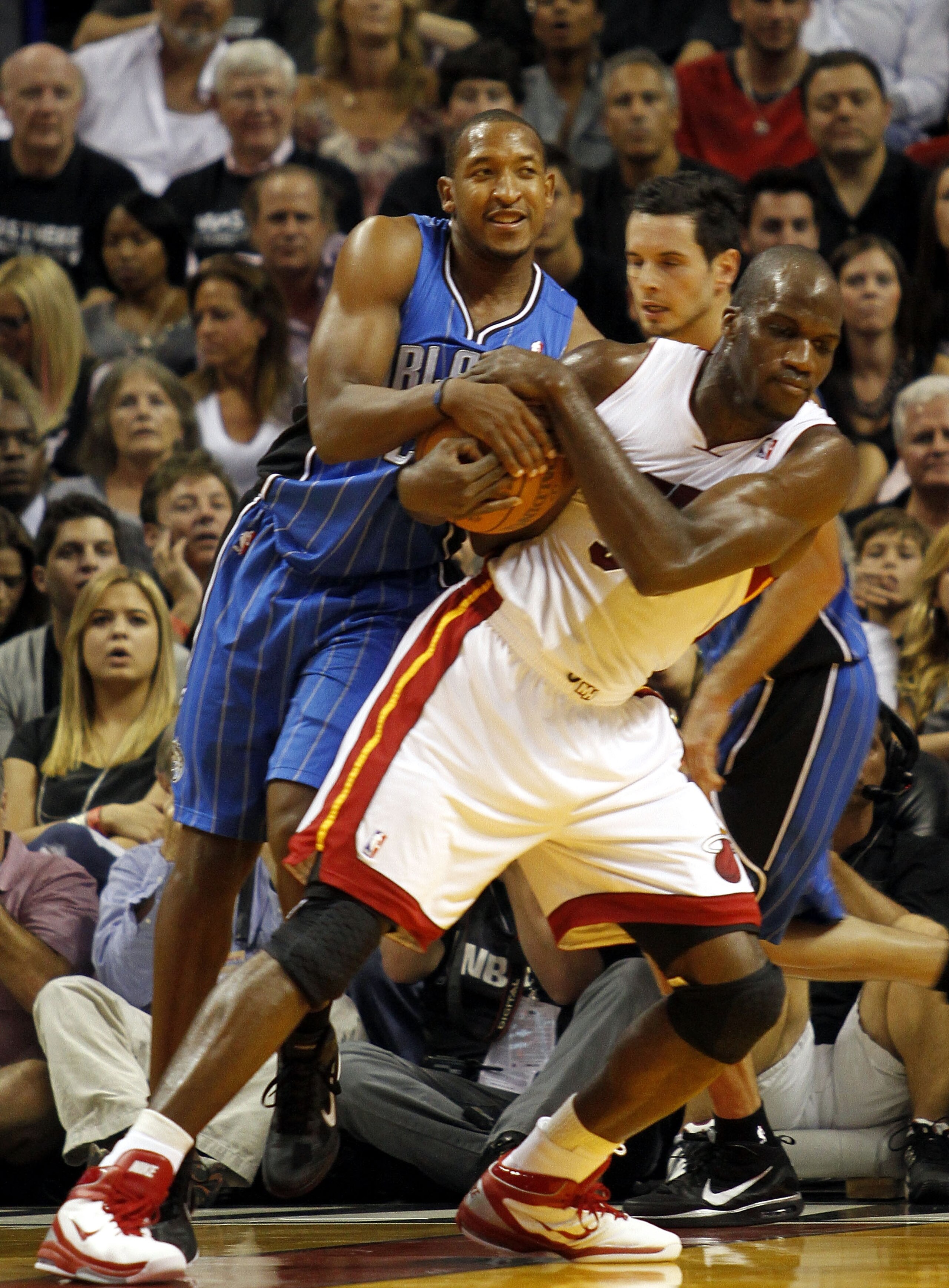 MIAMI - OCTOBER 29:  Guard Chris Duhon #25 of the Orlando Magic has a jump ball with center Joel Anthony #50 of the Miami Heat at American Airlines Arena on October 29, 2010 in Miami, Florida.  NOTE TO USER: User expressly acknowledges and agrees that, by