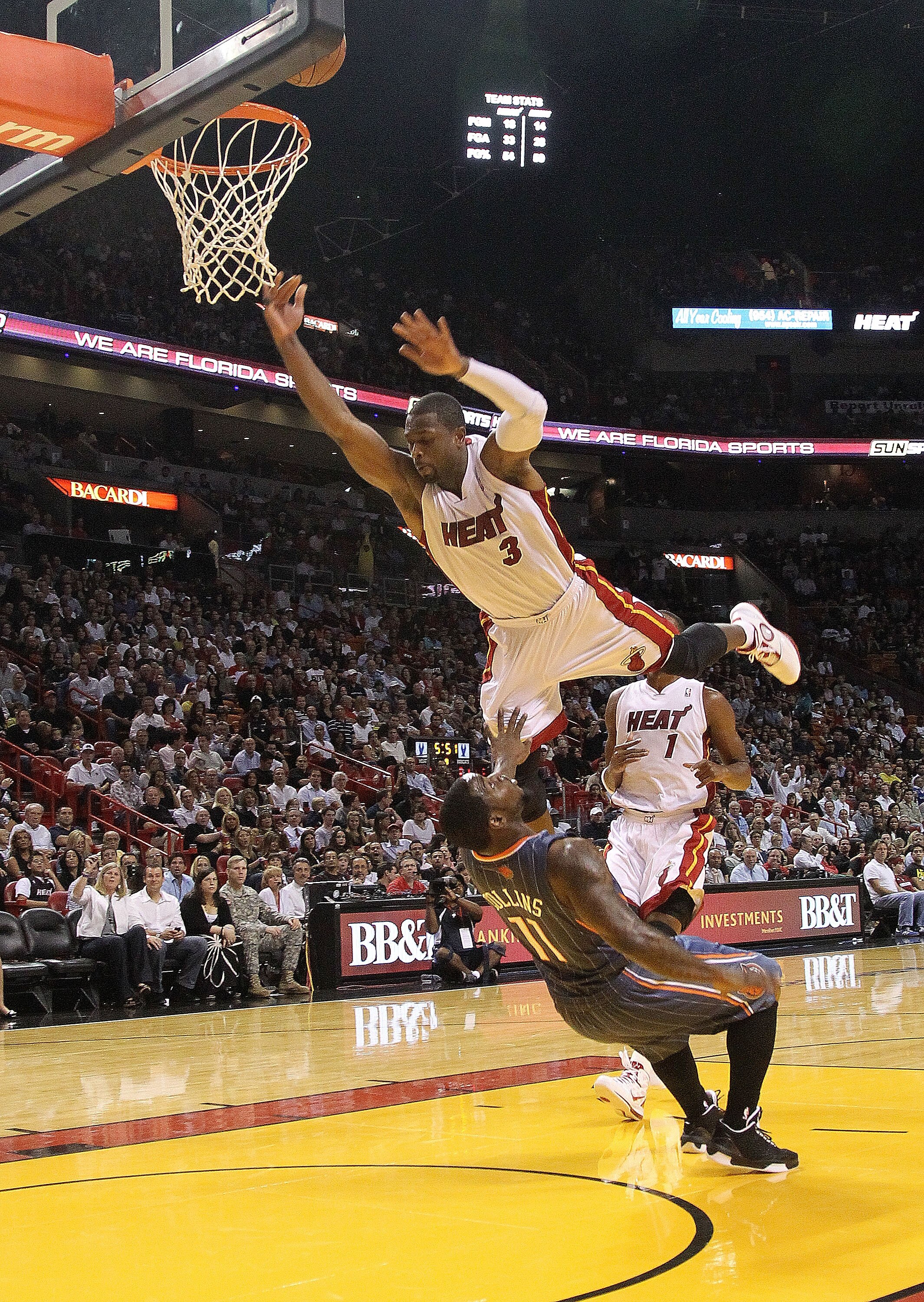 MIAMI - NOVEMBER 19: Dwyane Wade #3 of the Miami Heat is charged with an offensive foul against Sherron Collins #11 during a game against the Charlotte Bobcats at American Airlines Arena on November 19, 2010 in Miami, Florida. NOTE TO USER: User expressly