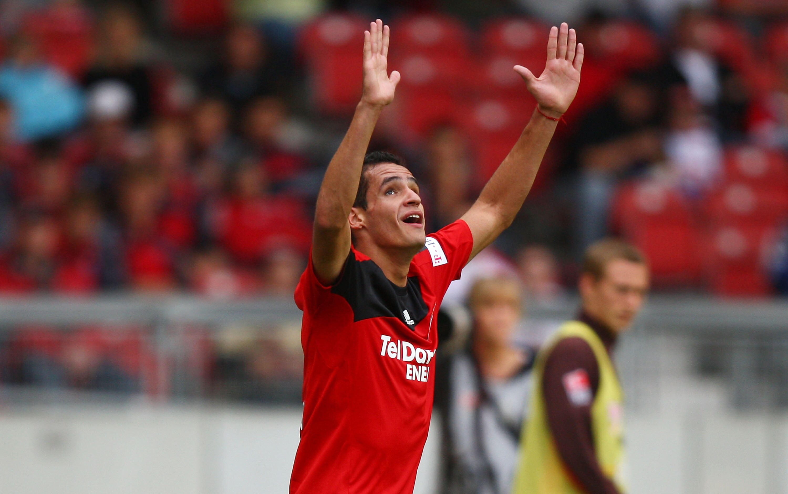 STUTTGART, GERMANY - AUGUST 23:  Renato Augusto of Leverkusen raises his arms during the Bundesliga match between VfB Stuttgart and Bayer Leverkusen at the Mercedes-Benz Arena on August 23, 2008 in Stuttgart, Germany. on August 23, 2008 in Stuttgart, Germ