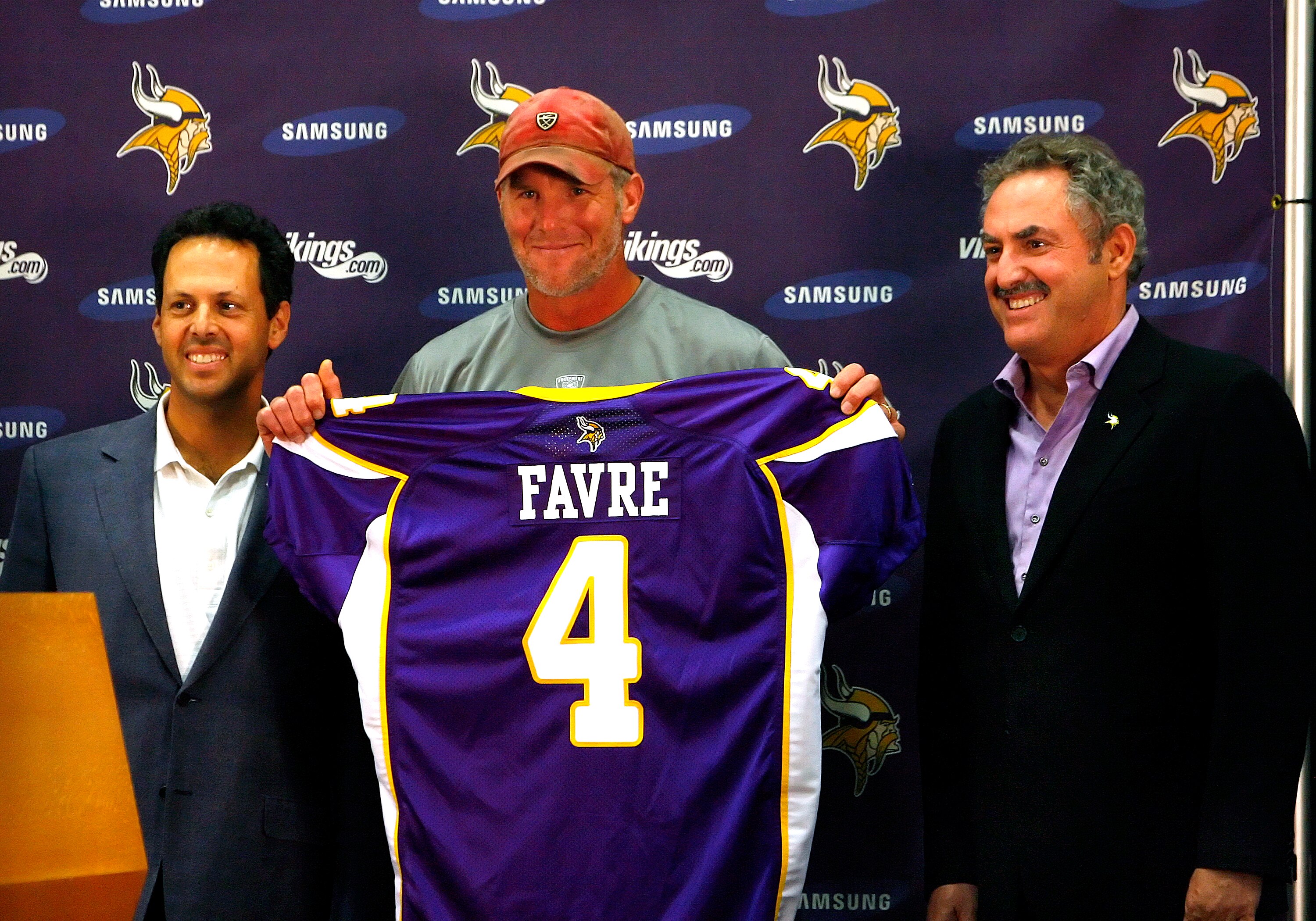 EDEN PRAIRIE, MN - AUGUST 18: Brett Favre (C), Mark Wilf (L) and Zygi Wilf show the media Favre's Minnesota Vikings jersey on August 18, 2009 at Winter Park in Eden Prairie, Minnesota. (Photo by Scott A. Schneider/Getty Images)