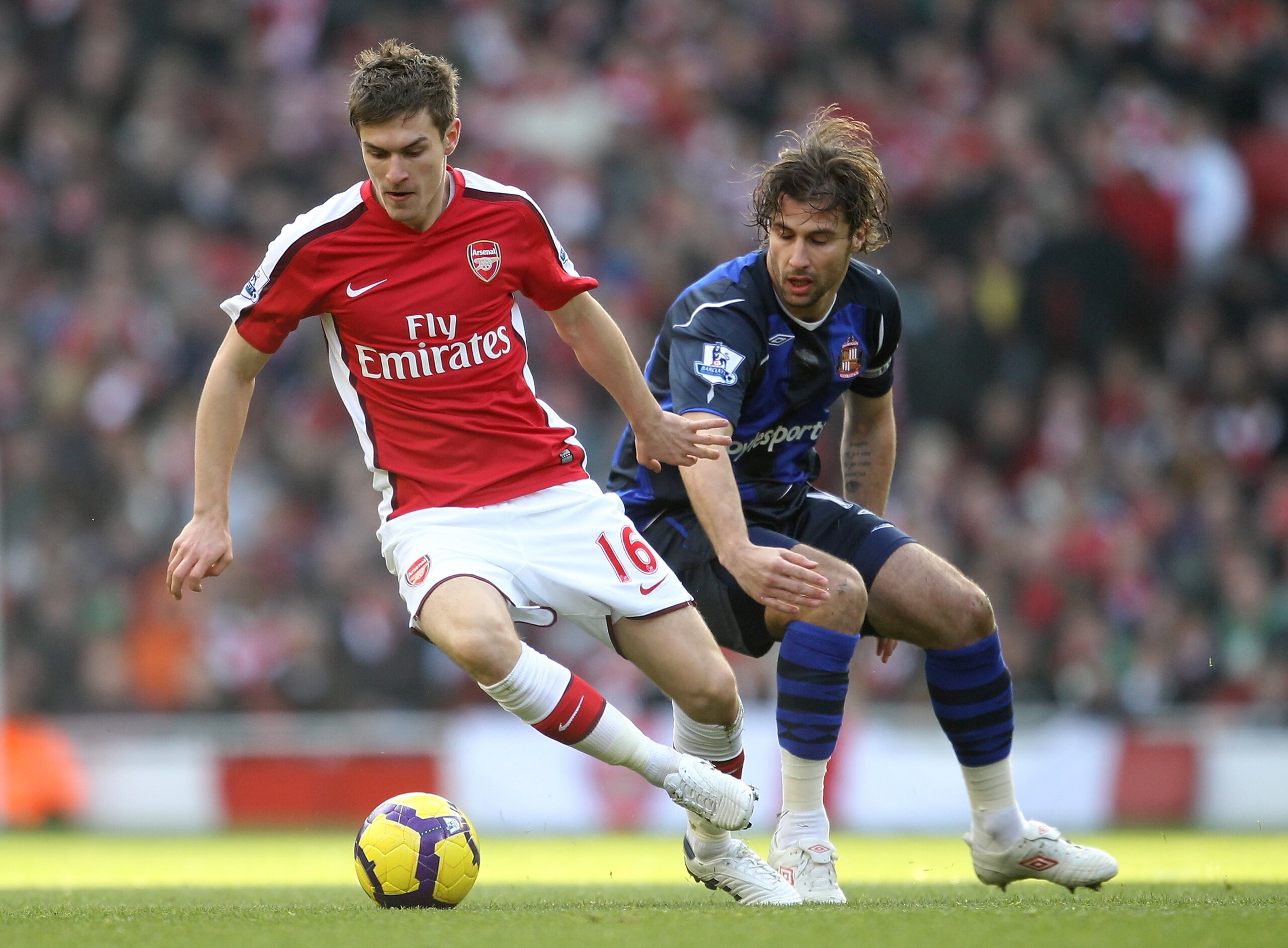 LONDON, ENGLAND - FEBRUARY 20:  Aaron Ramsey of Arsenal holds off Lorik Cana of Sunderland during the Barclays Premier League match between Arsenal and Sunderland at the Emirates Stadium on February 20, 2010 in London, England.  (Photo by Julian Finney/Ge