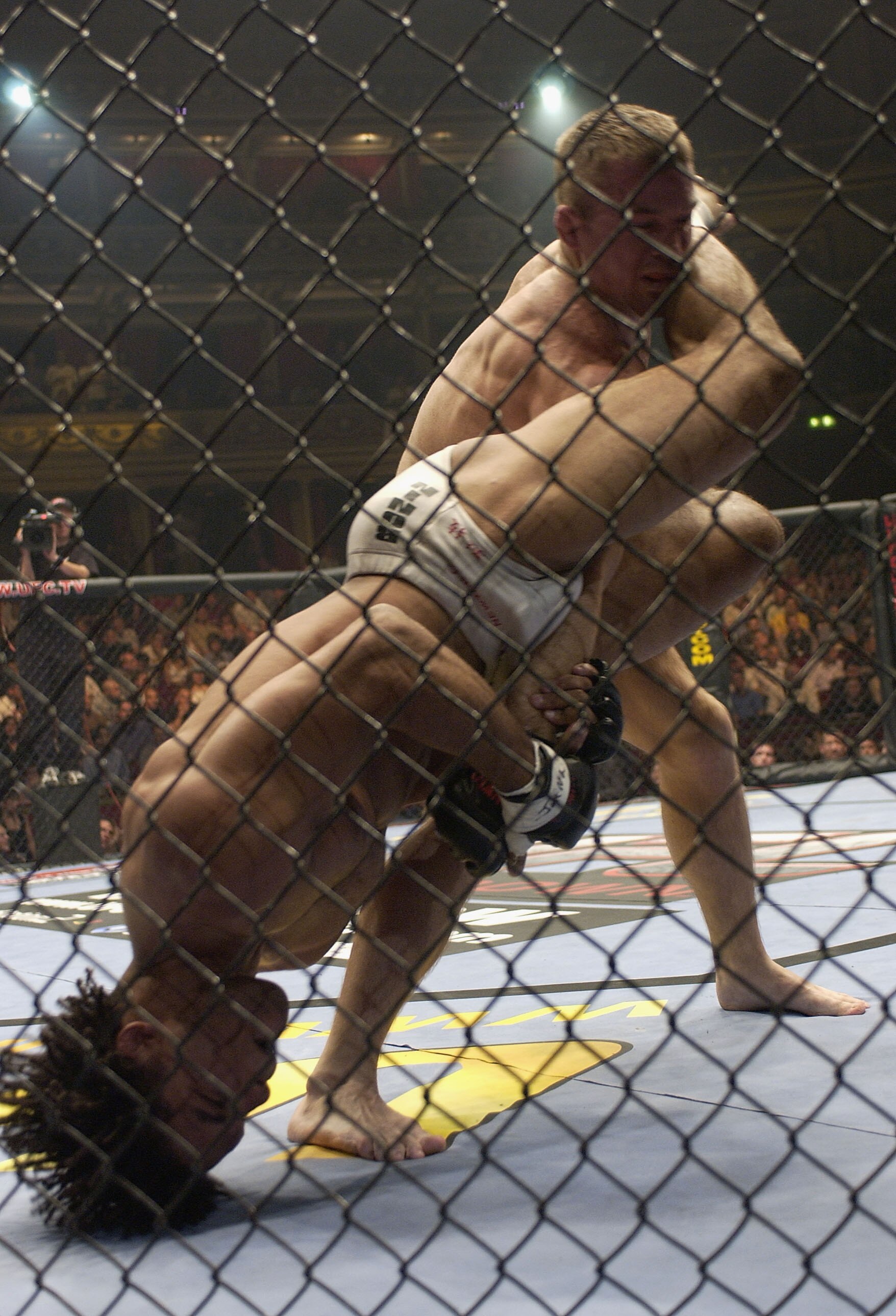 LONDON - JULY 13:  Matt Hughes of the USA battles with Carlos Newton of Canada during the Ultimate Fighting Championship, 'Brawl in the Royal Albert Hall', in the Royal Albert Hall London, England on July 13, 2002. (Photo by John Gichigi/Getty Images)