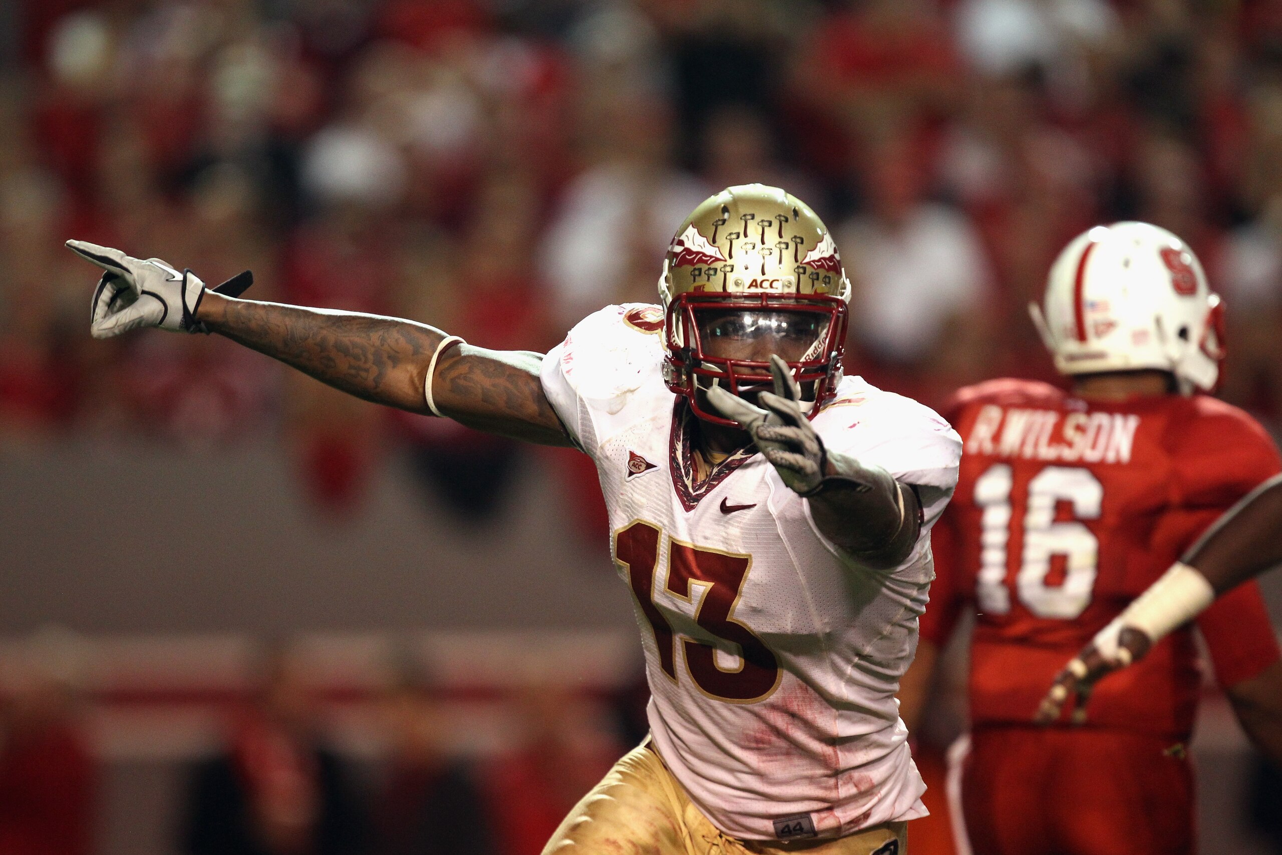 RALEIGH, NC - OCTOBER 28:  Timothy Orange #13 of the Florida State Seminoles celebrates after the defense recovered a fumble as Russell Wilson #16 of the North Carolina State Wolfpack walks off the field during their game at Carter-Finley Stadium on Octob