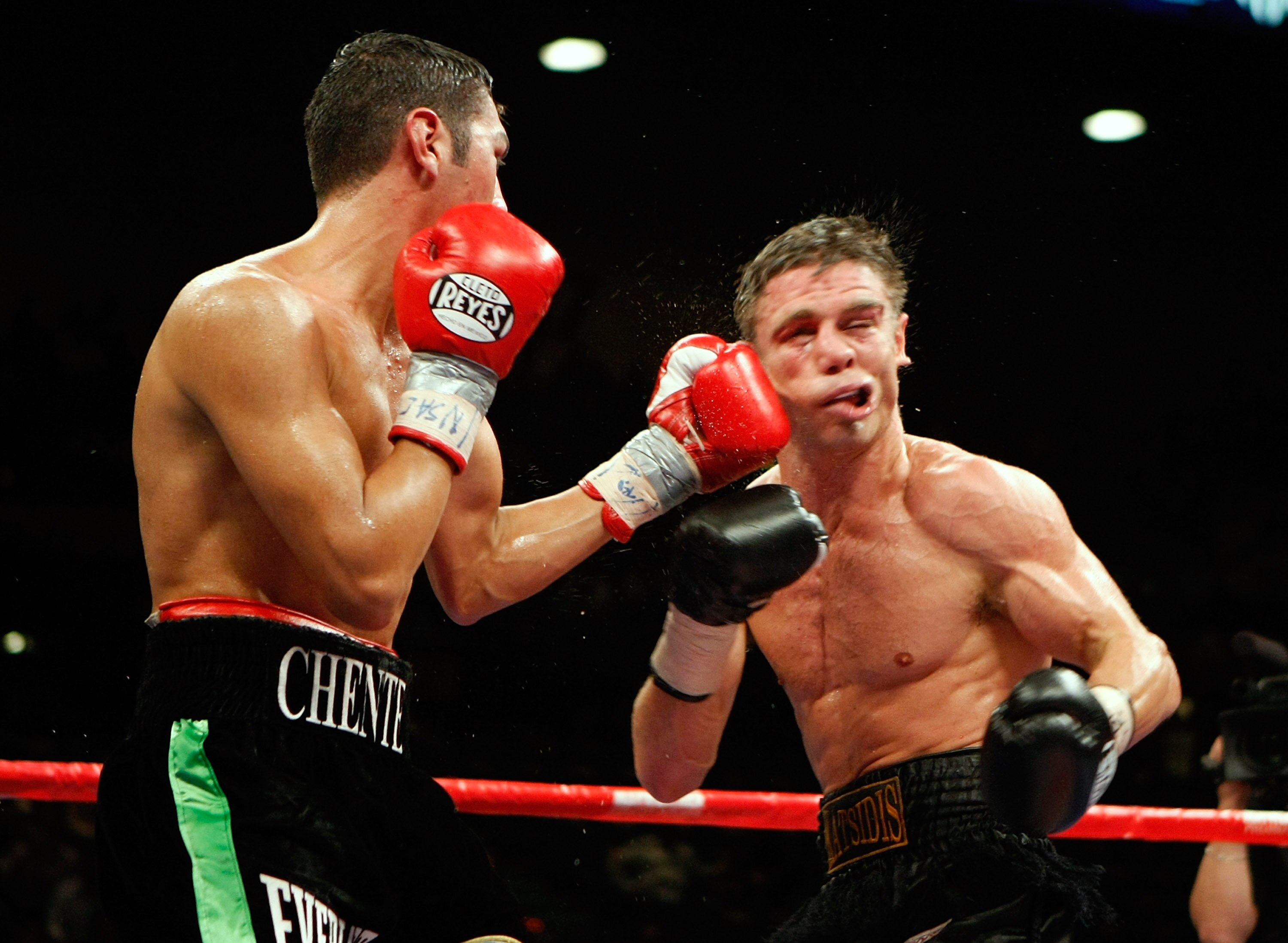 LAS VEGAS - SEPTEMBER 19:  Vincent Escobedo (L) hits Michael Katsidis in the seventh round of their WBO interim lightweight title fight at the MGM Grand Garden Arena September 19, 2009 in Las Vegas, Nevada. Katsidis won the title by split decision.  (Phot