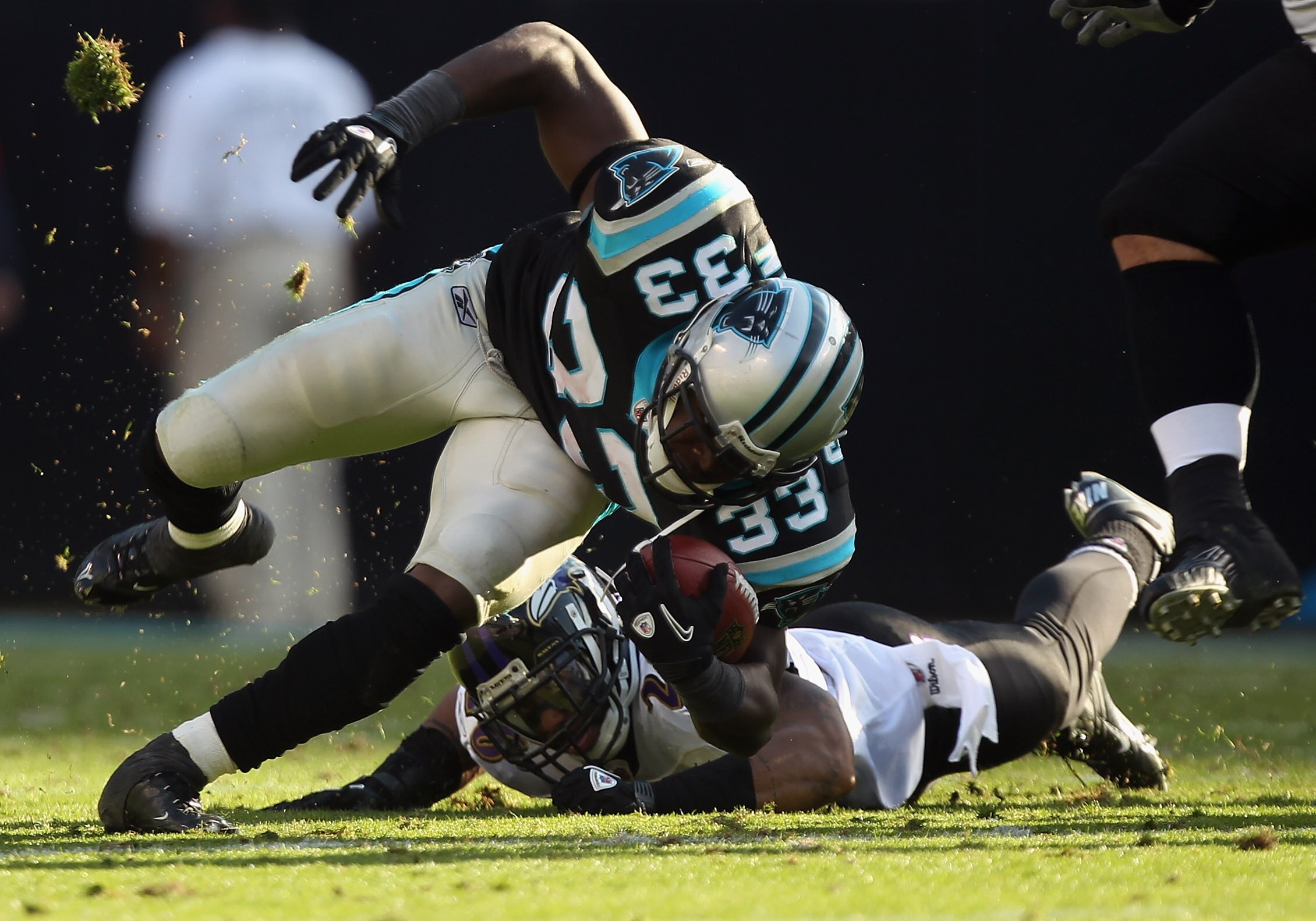CHARLOTTE, NC - NOVEMBER 21:  Dawan Landry #26 of the Baltimore Ravens tries to tackle Mike Goodson #33 of the Carolina Panthers at Bank of America Stadium on November 21, 2010 in Charlotte, North Carolina.  (Photo by Streeter Lecka/Getty Images)