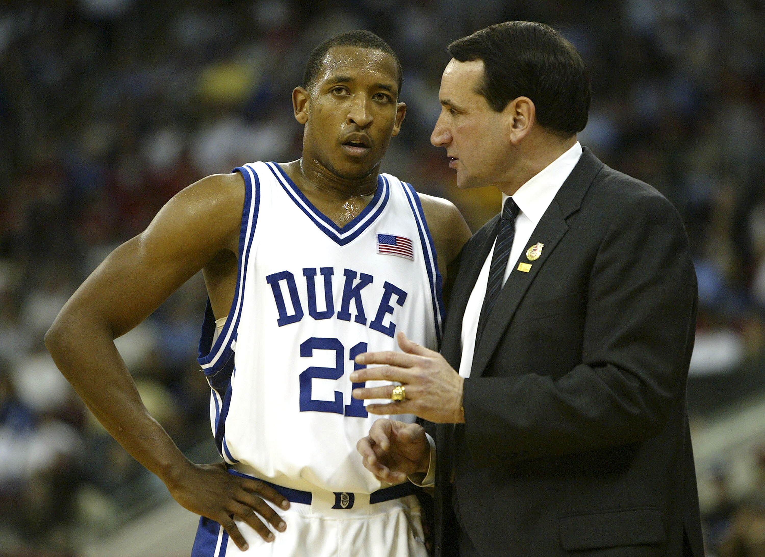 RALEIGH, NC - MARCH 20:  Head coach Mike Krzyzewski and Chris Duhon #21 of the Duke Blue Devils talk during the second round game of the NCAA Division I Men's Basketball Tournament against the Seton Hall Pirates on March 20, 2004 at RBC Center in Raleigh,