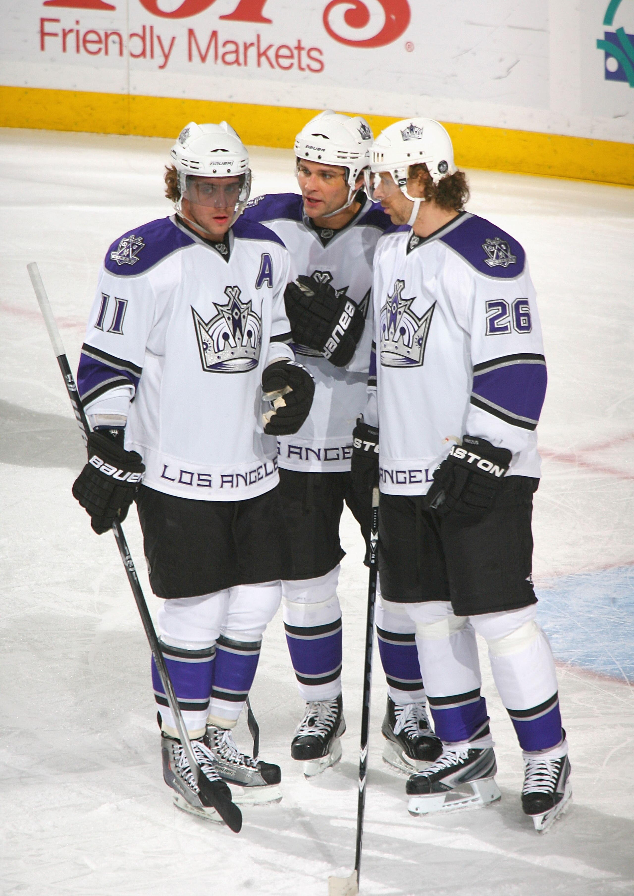 BUFFALO, NY - NOVEMBER 19: Anze Kopitar #11, Davis Drewiske #44, and Michal Handzus #26 of the Los Angeles Kings talk during a stoppage in play against the Buffalo Sabres at HSBC Arena on November 19, 2010 in Buffalo, New York.  (Photo by Rick Stewart/Get