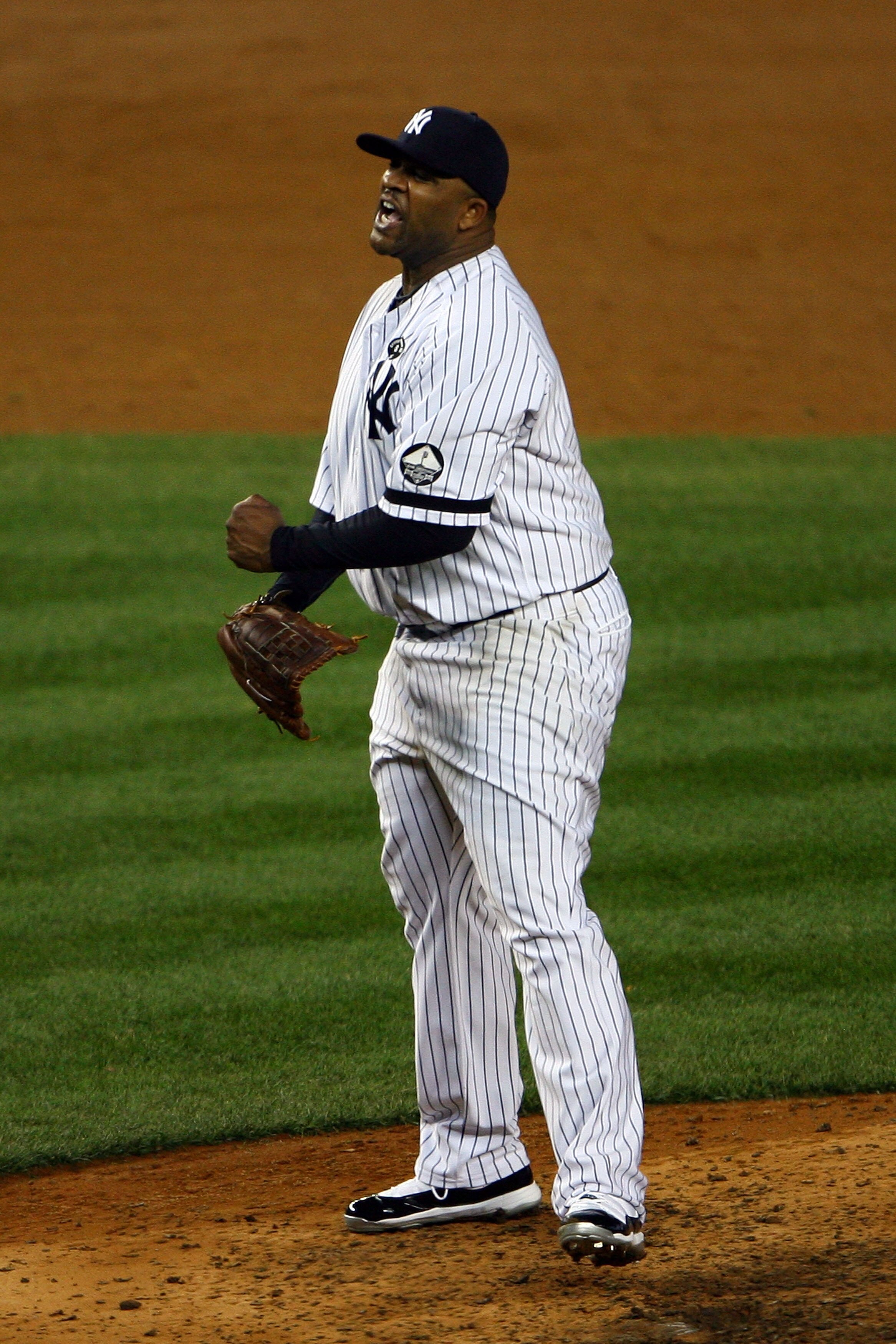NEW YORK - OCTOBER 20:  CC Sabathia #52 of the New York Yankees reacts after he struck out Mitch Moreland #18 of the Texas Rangers to end the top of the sixth inning of Game Five of the ALCS during the 2010 MLB Playoffs at Yankee Stadium on October 20, 20
