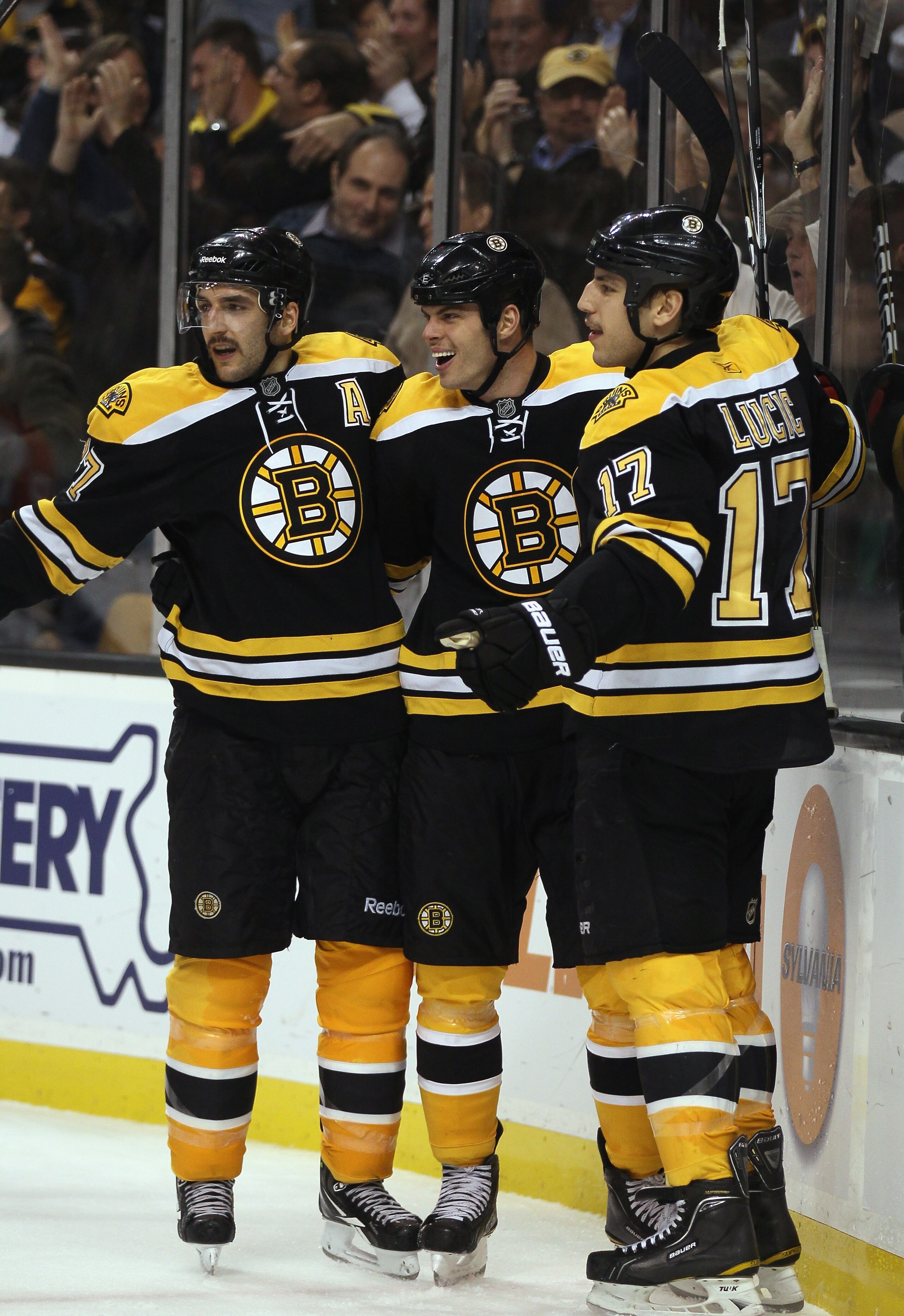 BOSTON - NOVEMBER 18:  Milan Lucic #17 of the Boston Bruins is congratulated by teammates Nathan Horton #18 and Patrice Bergeron #37 after Lucic scored his second goal against the Florida Panther on November 18, 2010 at the TD Garden in Boston, Massachuse