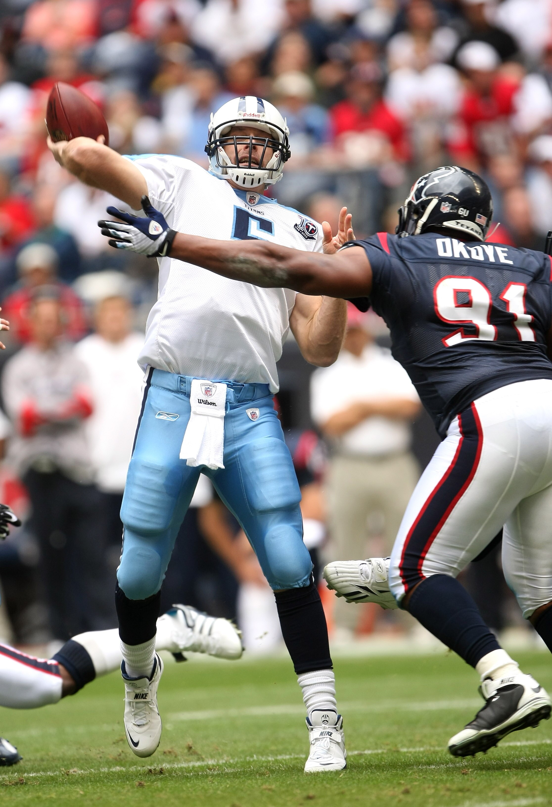 HOUSTON - DECEMBER 14:  Quarterback Kerry Collins #5 of the Tennessee Titans throws a pass over defensive tackle Amobi Okoye #91 of the Houston Texans on December 14, 2008 at Reliant Stadium in Houston, Texas.  (Photo by Stephen Dunn/Getty Images)