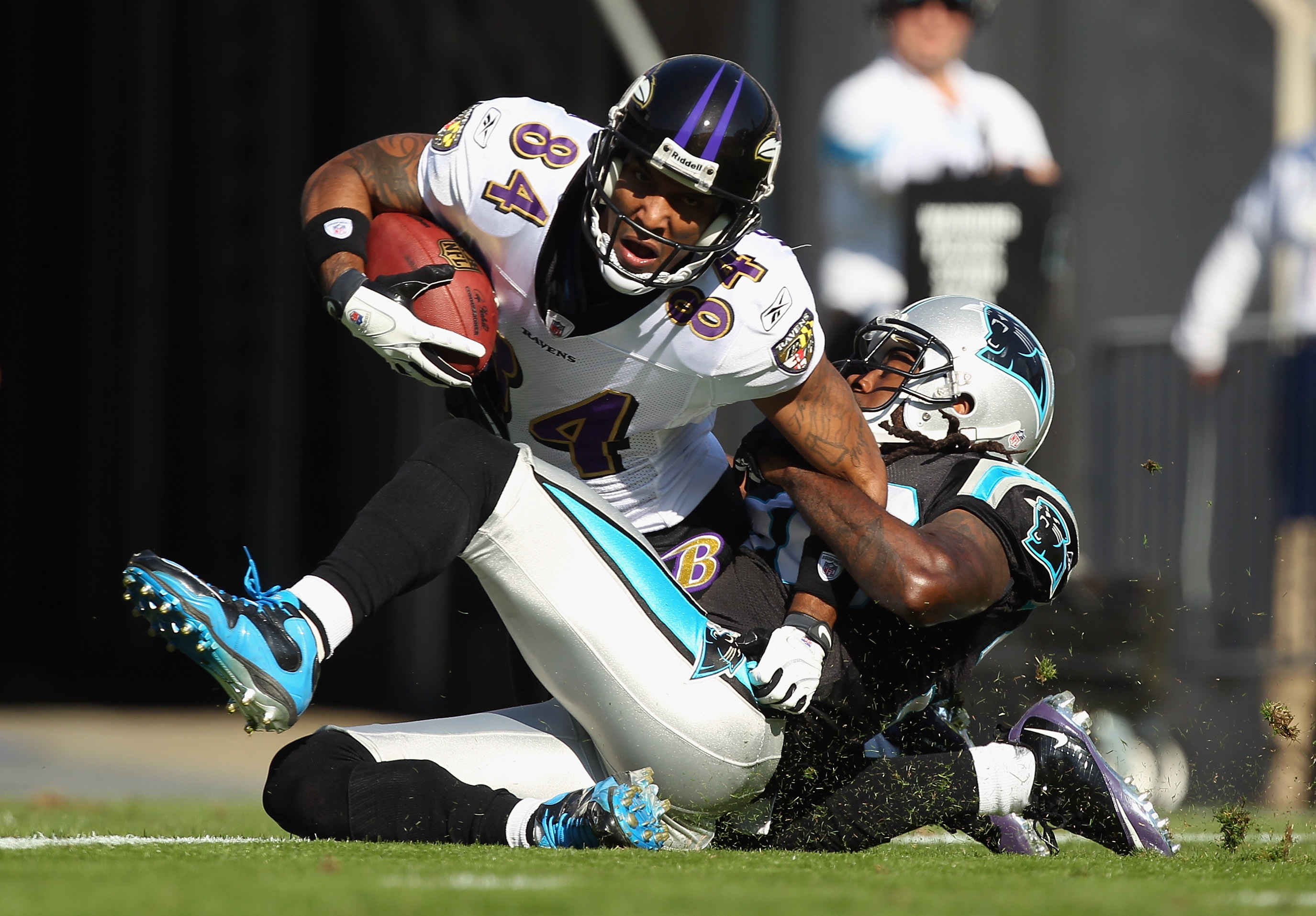 CHARLOTTE, NC - NOVEMBER 21:  T.J. Houshmandzadeh #84 of the Baltimore Ravens scores a touchdown as he is tackled by Charles Godfrey #30 of the Carolina Panthers at Bank of America Stadium on November 21, 2010 in Charlotte, North Carolina.  (Photo by Stre