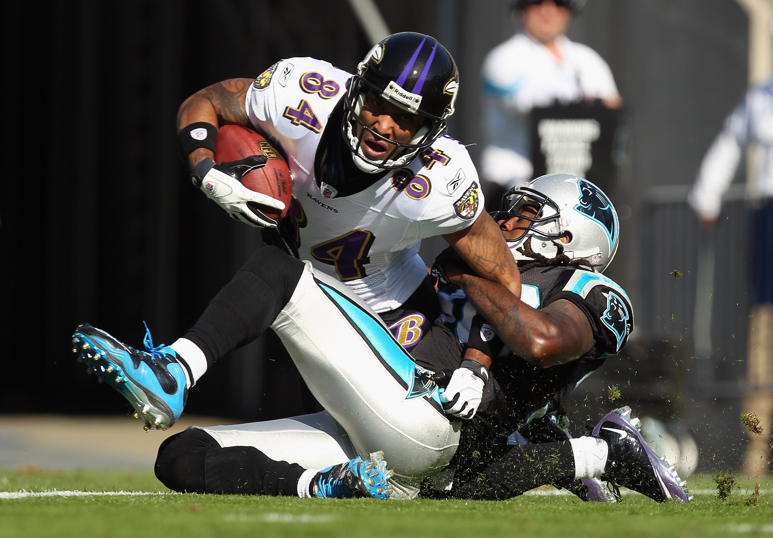 CHARLOTTE, NC - NOVEMBER 21:  T.J. Houshmandzadeh #84 of the Baltimore Ravens scores a touchdown as he is tackled by Charles Godfrey #30 of the Carolina Panthers at Bank of America Stadium on November 21, 2010 in Charlotte, North Carolina.  (Photo by Stre