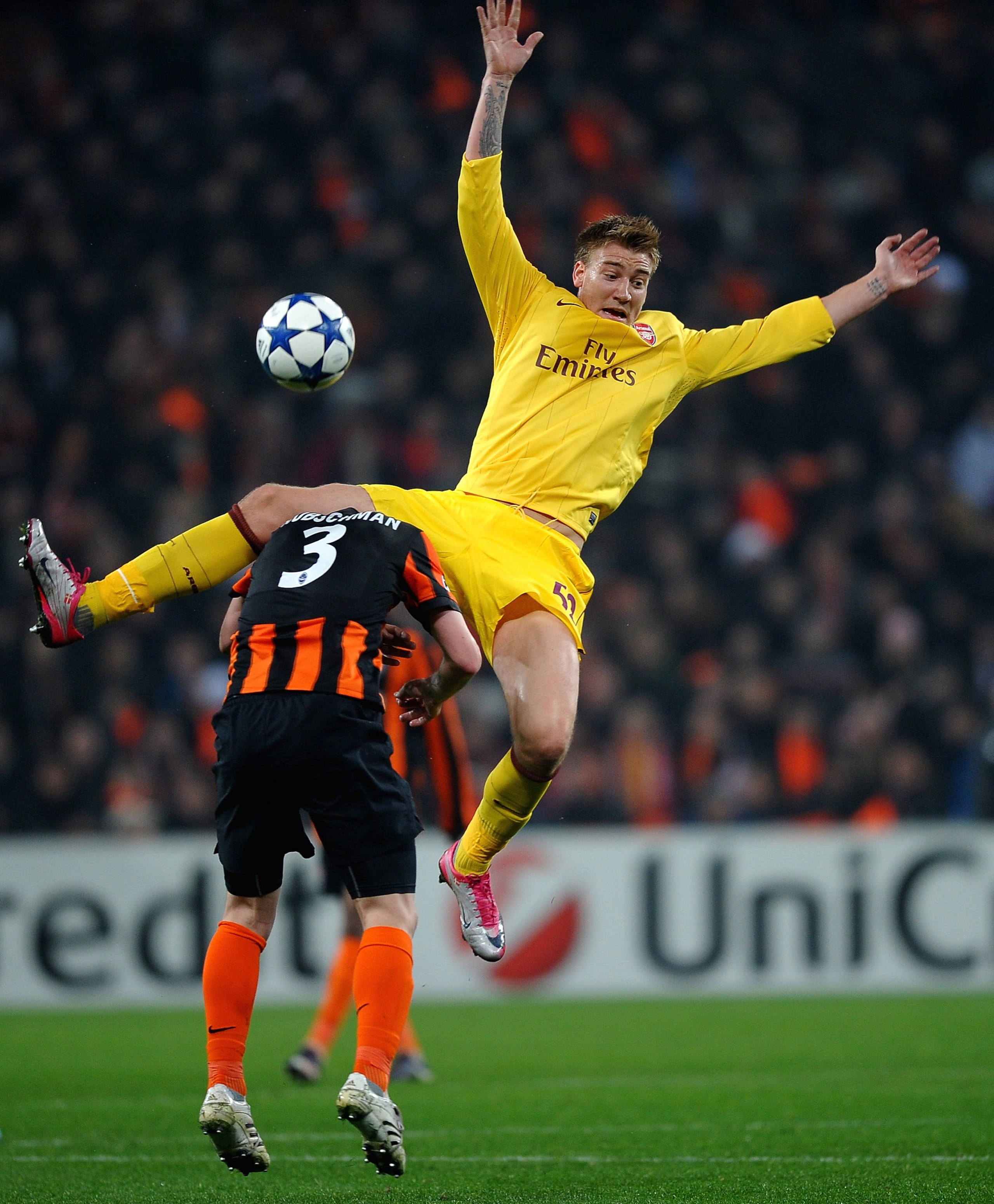 DONETSK, UKRAINE - NOVEMBER 03:  Nicklas Bendtner of Arsenal battles with Tomas Hubschman of FC Shakhtar Donetsk during the Champions League Group H match between FC Shakhtar Donetsk and Arsenal at the Donbass Arena on November 3, 2010 in Donetsk, Ukraine