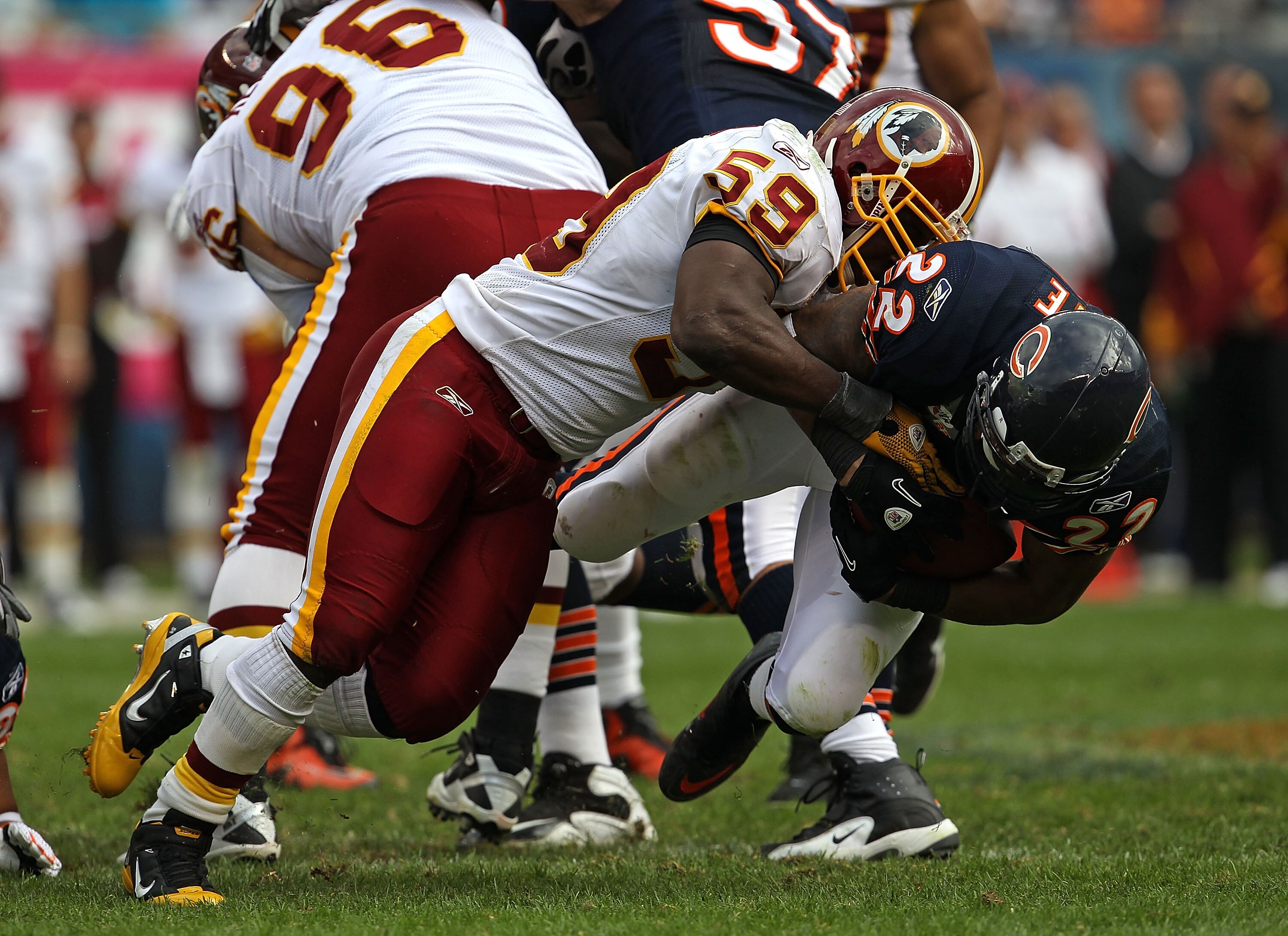 CHICAGO - OCTOBER 24: Matt Forte #22 of the Chicago Bears is dropped by London Fletcher #59 of the Washington Redskins at Soldier Field on October 24, 2010 in Chicago, Illinois. The Redskins defeated the Bears 17-14. (Photo by Jonathan Daniel/Getty Images