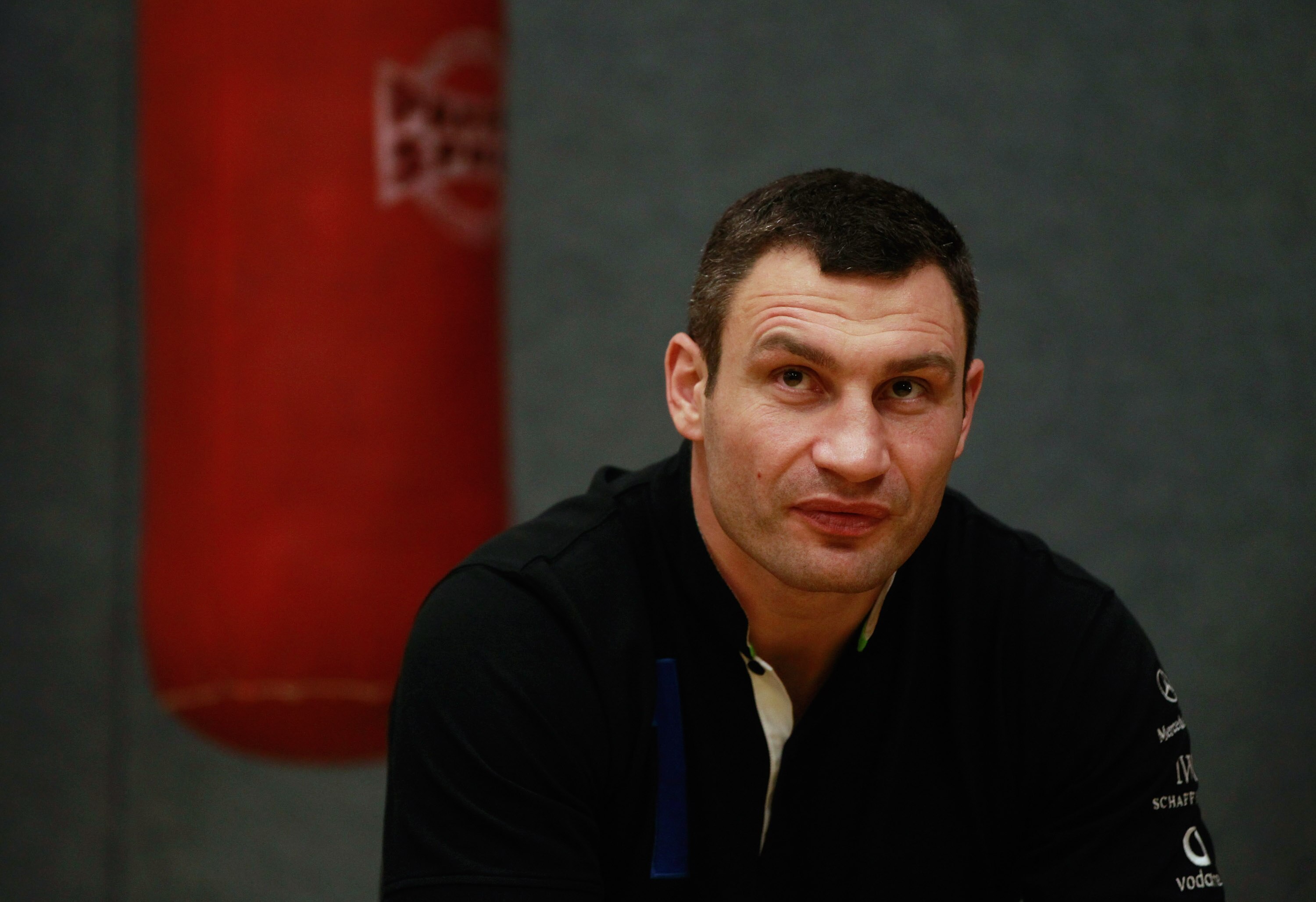 BERLIN - NOVEMBER 16:  Pro boxer Vitali Klitschko sits prior to coaching young boxers at the 'Kick im Boxring' at the TC Gruen Weiss boxing hall in Treptow district on November 16, 2010 in Berlin, Germany. The 'Kick im Boxring' project encourages youth in