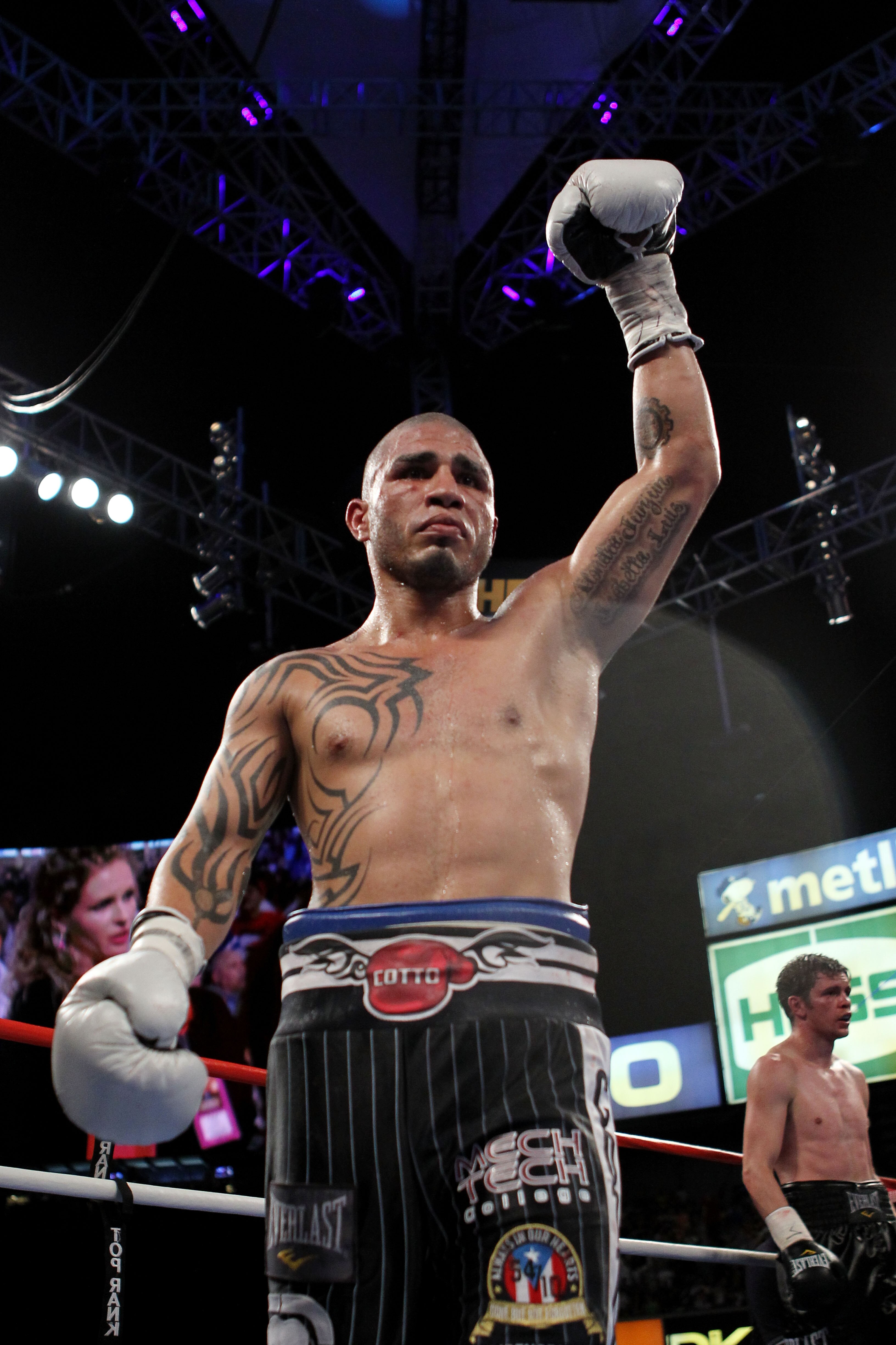 NEW YORK - JUNE 05:  (L-R) Miguel Cotto of Puerto Rico prematurely celebrates during his bout with Yuri Foreman after Foreman's corner throws in a towel during the WBA world super welterweight title fight on June 5, 2010 at Yankee Stadium in the Bronx bor