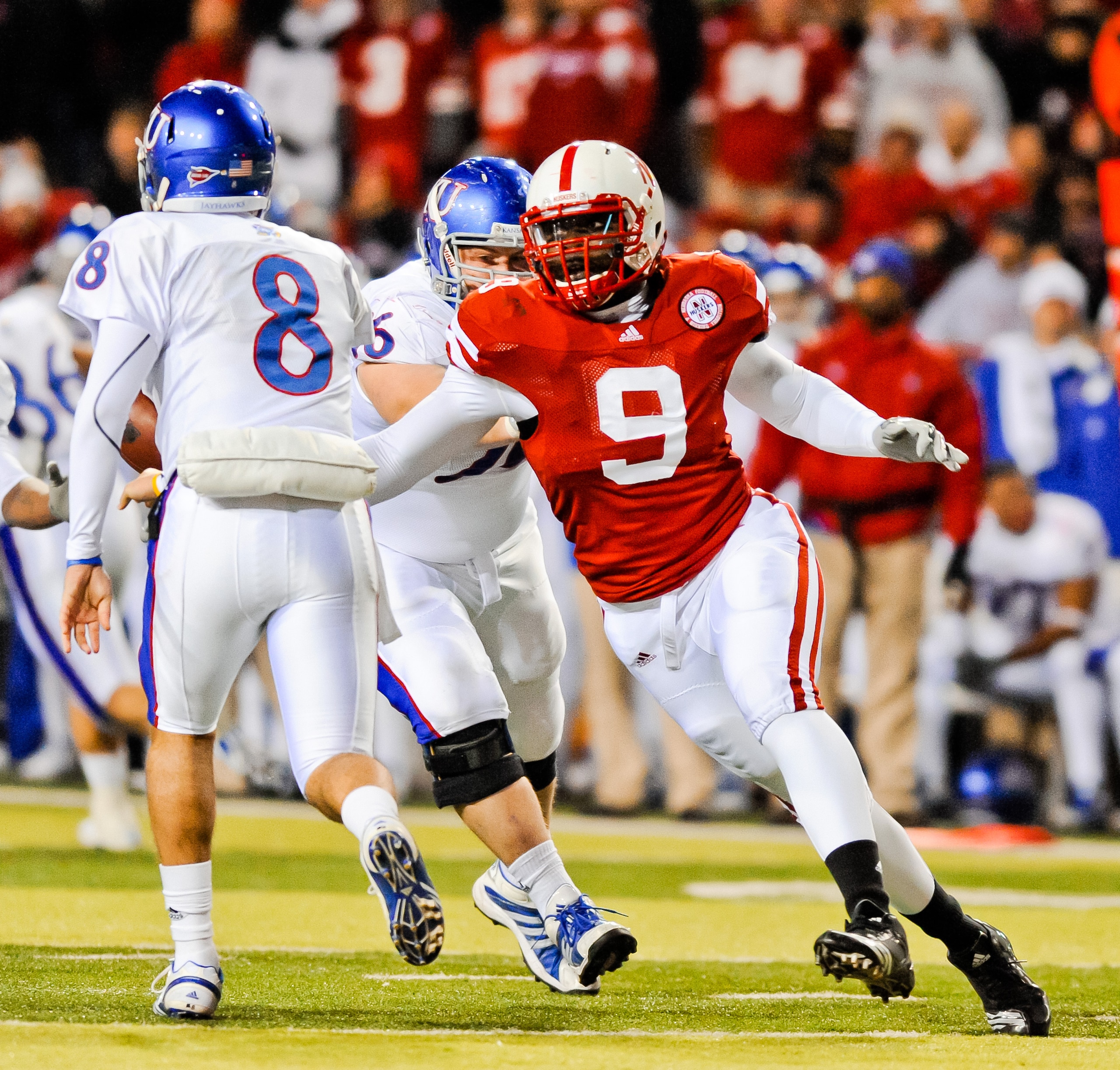 LINCOLN, NE - NOVEMBER 13: Joe Broekemeier #9 of the Nebraska Cornhuskers takes aim on Quinn Mecham #8 of the Kansas Jayhawks during their game at Memorial Stadium on November 13, 2010 in Lincoln, Nebraska. Nebraska Defeated Kansas 20-3. (Photo by Eric Fr