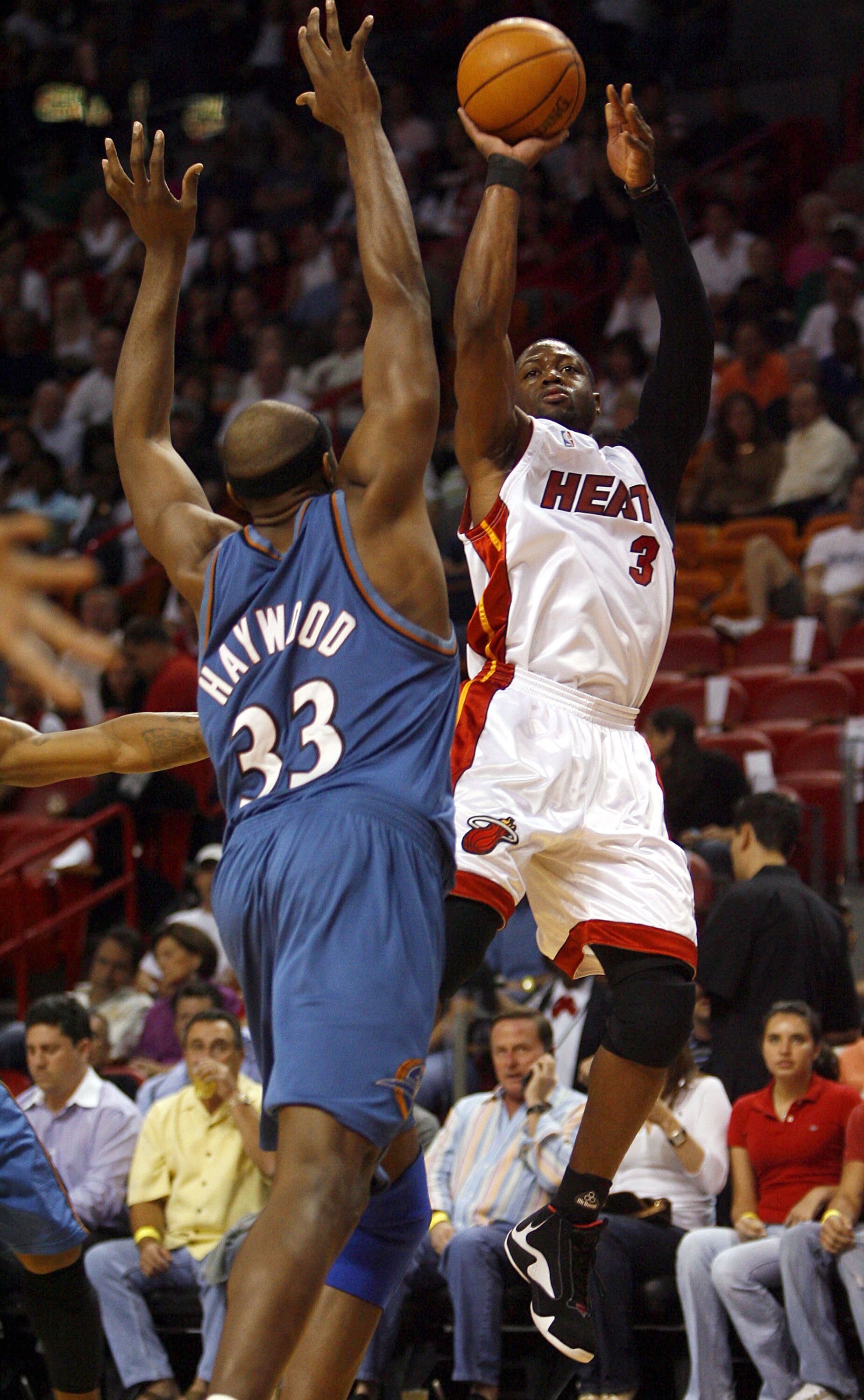 MIAMI - APRIL 11:  Guard Dwyane Wade #3 of the Miami Heat jumps and shoots over Brendan Haywood #33 of the Washington Wizards on April 11, 2007 at the American Airlines Arena in Miami, Florida.  NOTE TO USER: User expressly acknowledges and agrees that, b