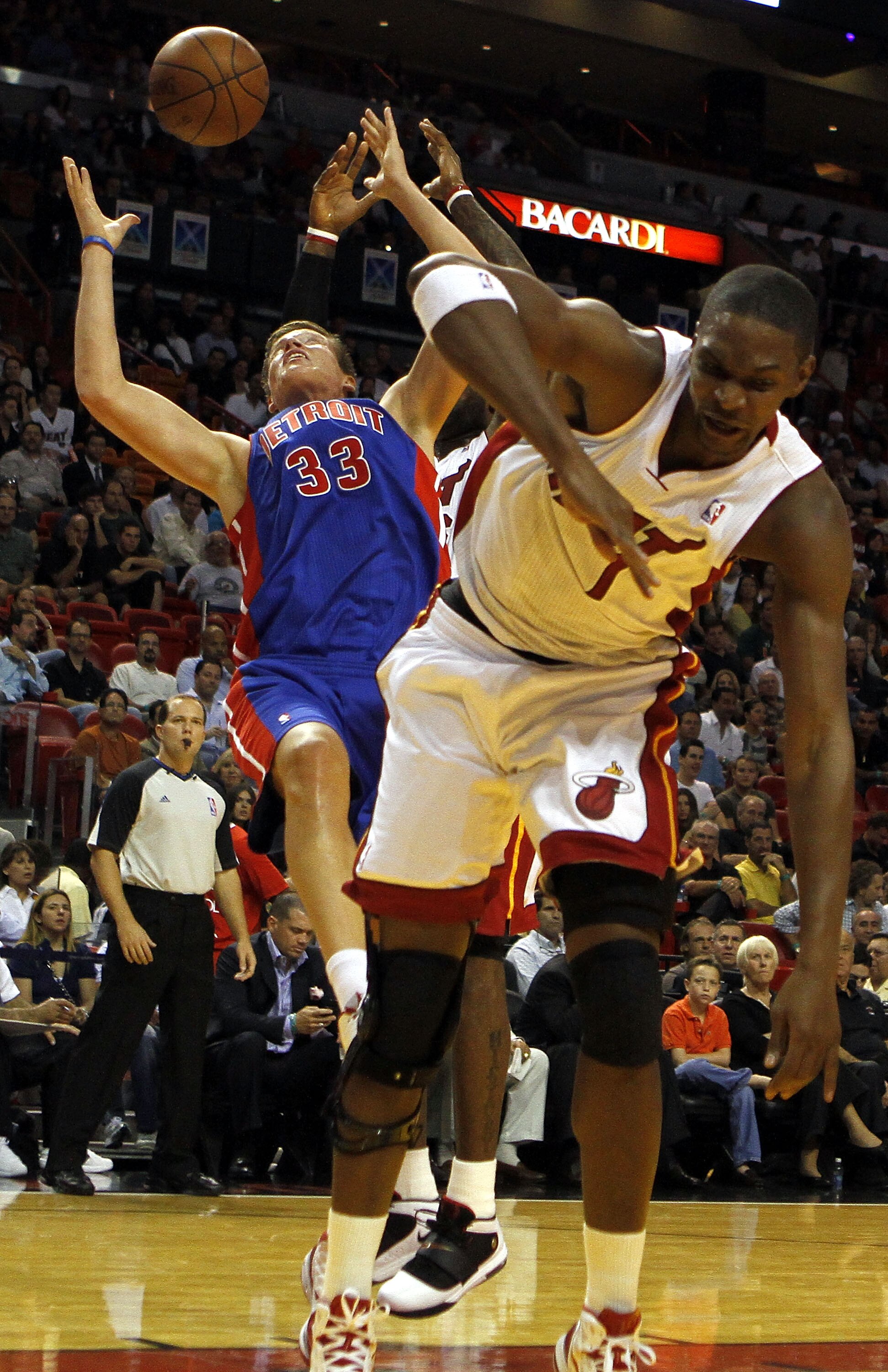 MIAMI - OCTOBER 05:  Center Chris Bosh #1 of the Miami Heat (L) battles Forward Jonas Jerebko #33 of the Detroit Pistons on October 5, 2010 in Miami, Florida.  NOTE TO USER: User expressly acknowledges and agrees that, by downloading and or using this pho
