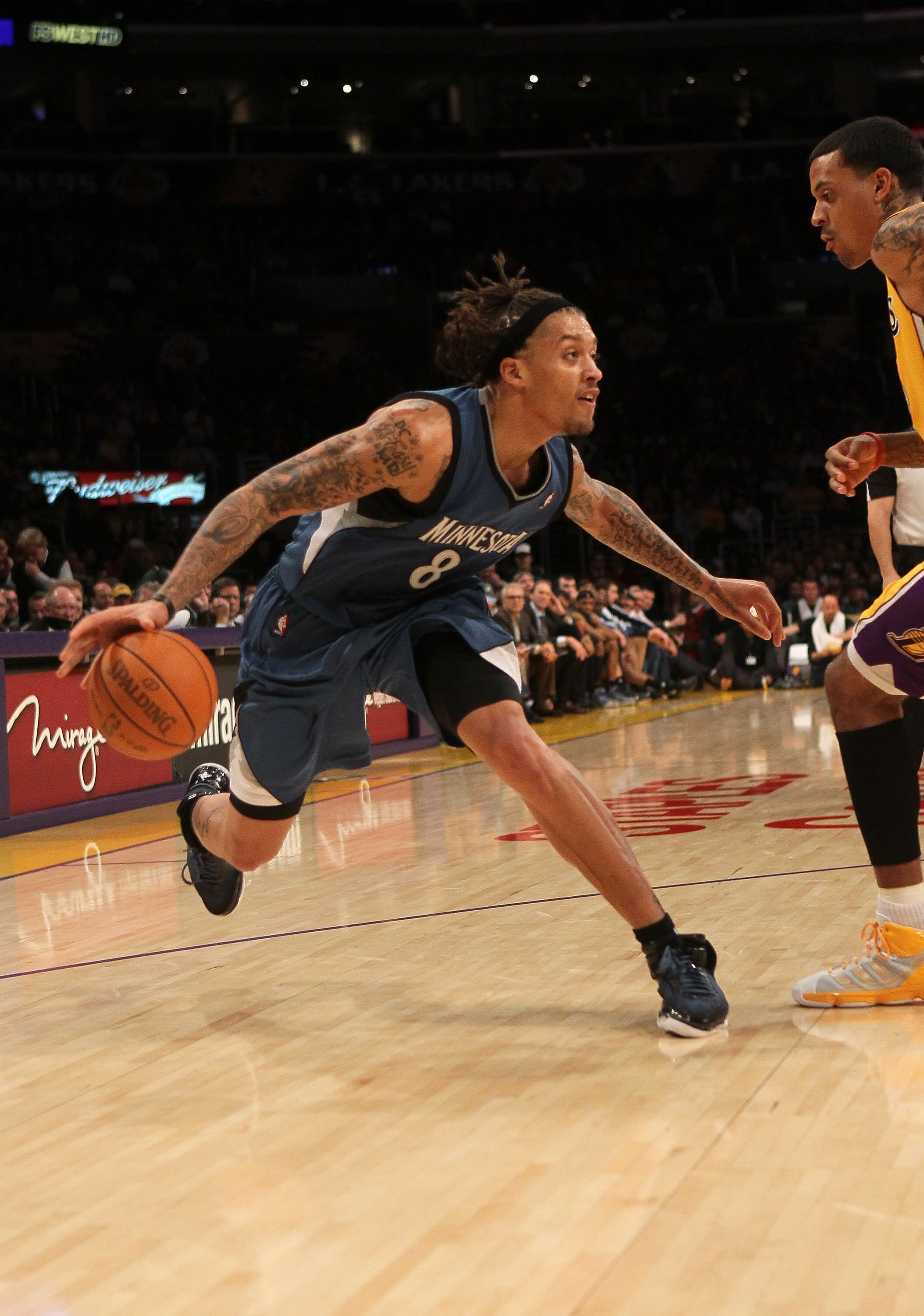 LOS ANGELES, CA - NOVEMBER 09:  Michael Beasley #8 of the Minnesota Timberwolves drives against Matt Barnes #9 of the Los Angeles Lakers at Staples Center on November 9, 2010 in Los Angeles, California. The Lakers won 99-94.   NOTE TO USER: User expressly