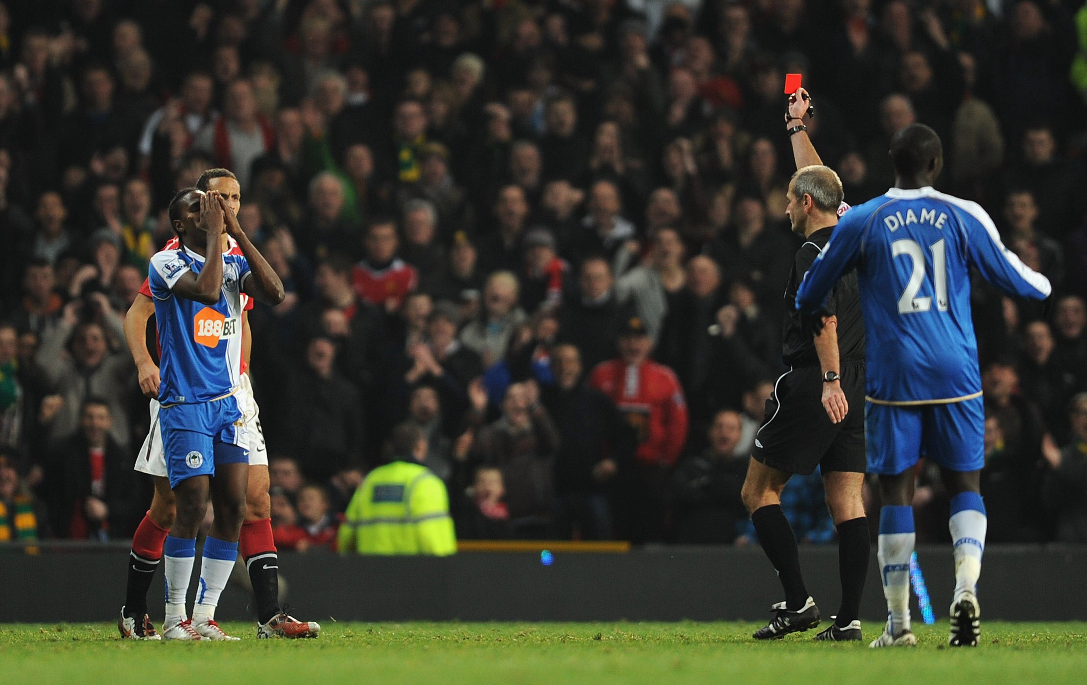 MANCHESTER, ENGLAND - NOVEMBER 20: Hugo Rodallega of Wigan reacts as he is sent off by referee Martin Atkinson during the Barclays Premier League match between Manchester United and Wigan Athletic at Old Trafford on November 20, 2010 in Manchester, Englan
