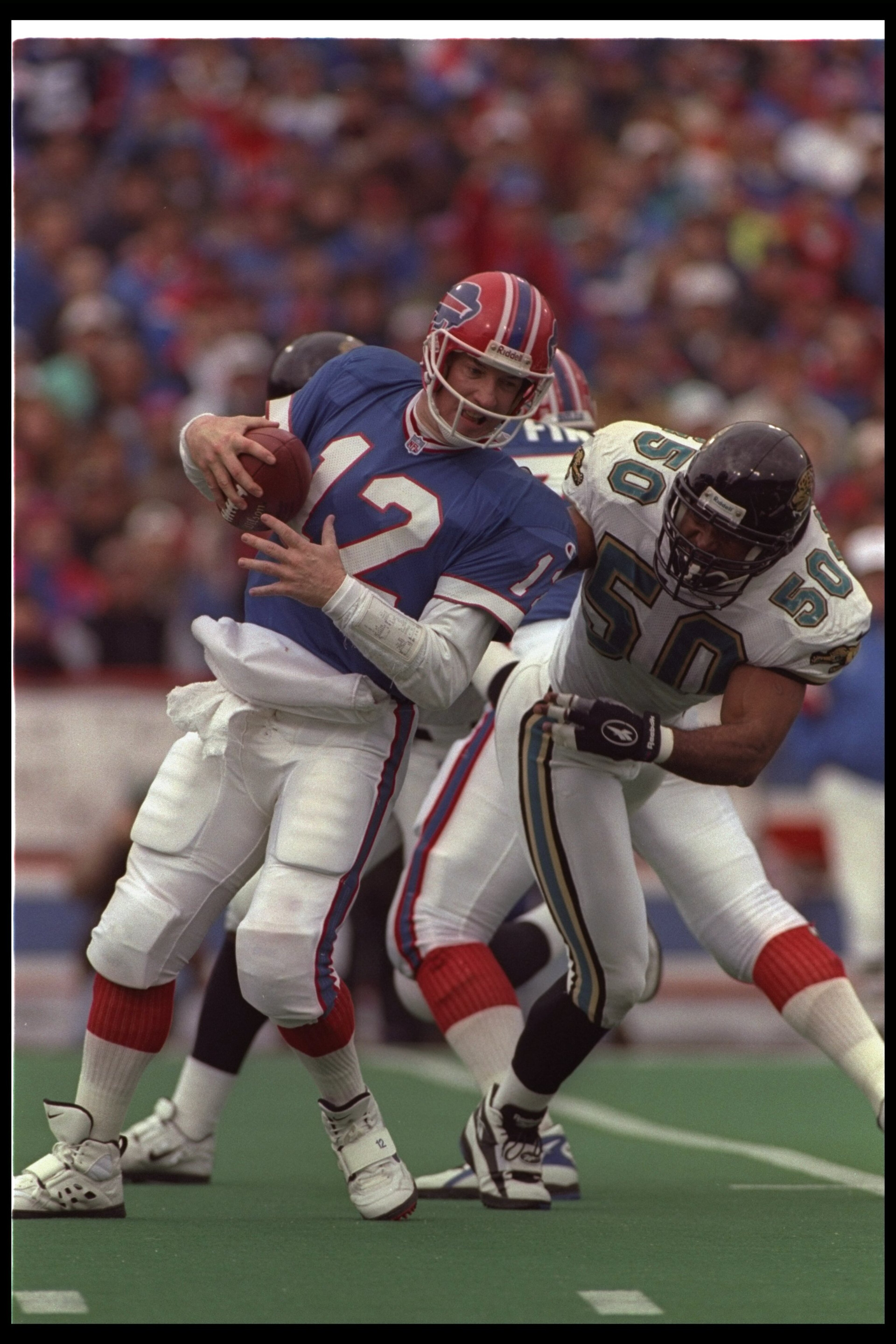 28 Dec 1996: Linebacker Eddie Robinson of the Jacksonville Jaguars tackles Buffalo Bills quarterback Jim Kelly during a playoff game at Rich Stadium in Orchard Park, New York. The Jaguars won the game, 30-27. Mandatory Credit: Rick Stewart /Allsport 28 Dec 1996: Linebacker Eddie Robinson of the Jacksonville Jaguars tackles Buffalo Bills quarterback Jim Kelly during a playoff game at Rich Stadium in Orchard Park, New York. The Jaguars won the game, 30-27. Mandatory Credit: Rick Stewart /Allsport