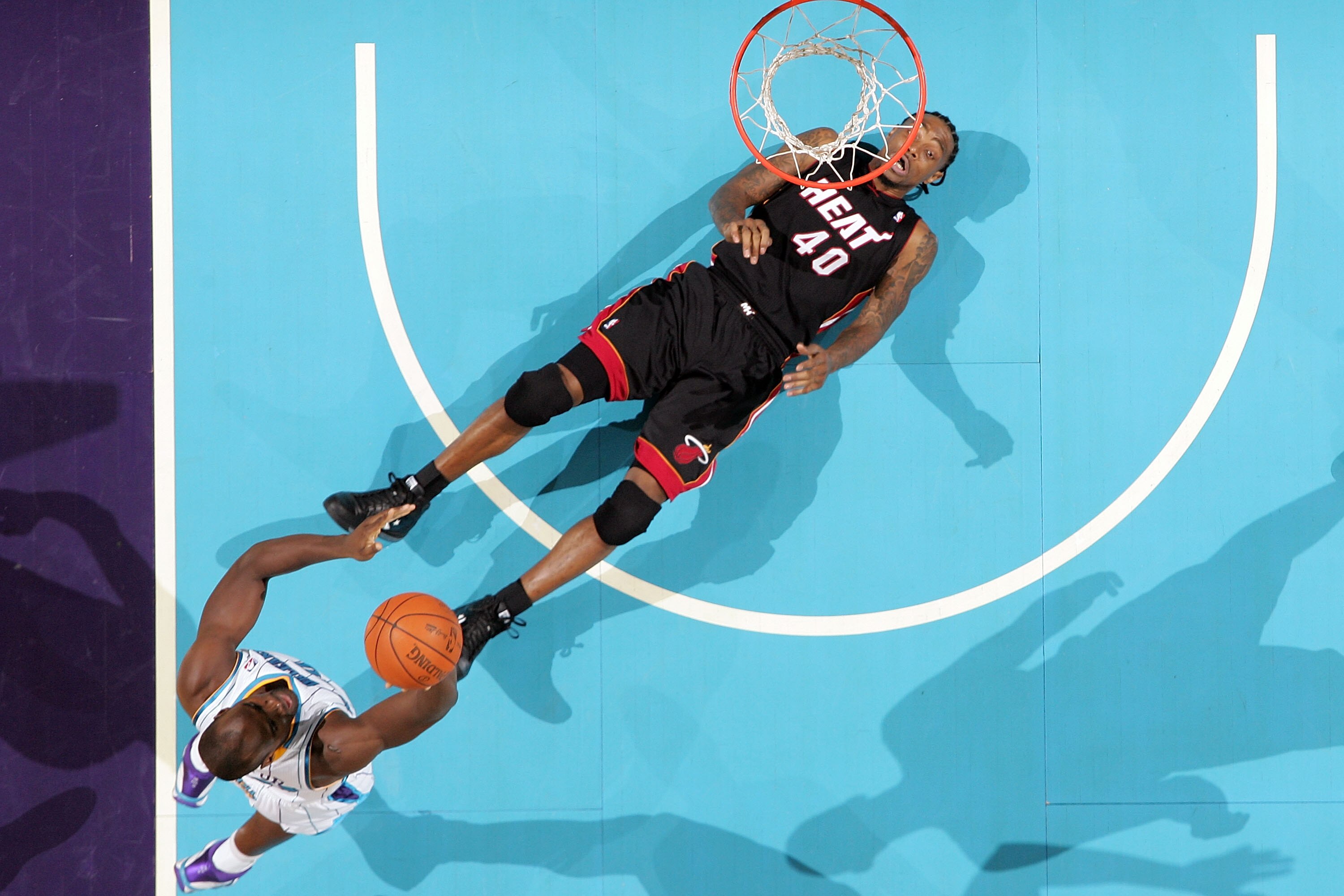 NEW ORLEANS - NOVEMBER 05:  Emeka  Okafor #50 of the New Orleans Hornets shoots the ball over Udonis Haslem #40 of the Miami Heat at the New Orleans Arena on November 5, 2010 in New Orleans, Louisiana.  The Hornets defeated the Heat 96-93.  NOTE TO USER: