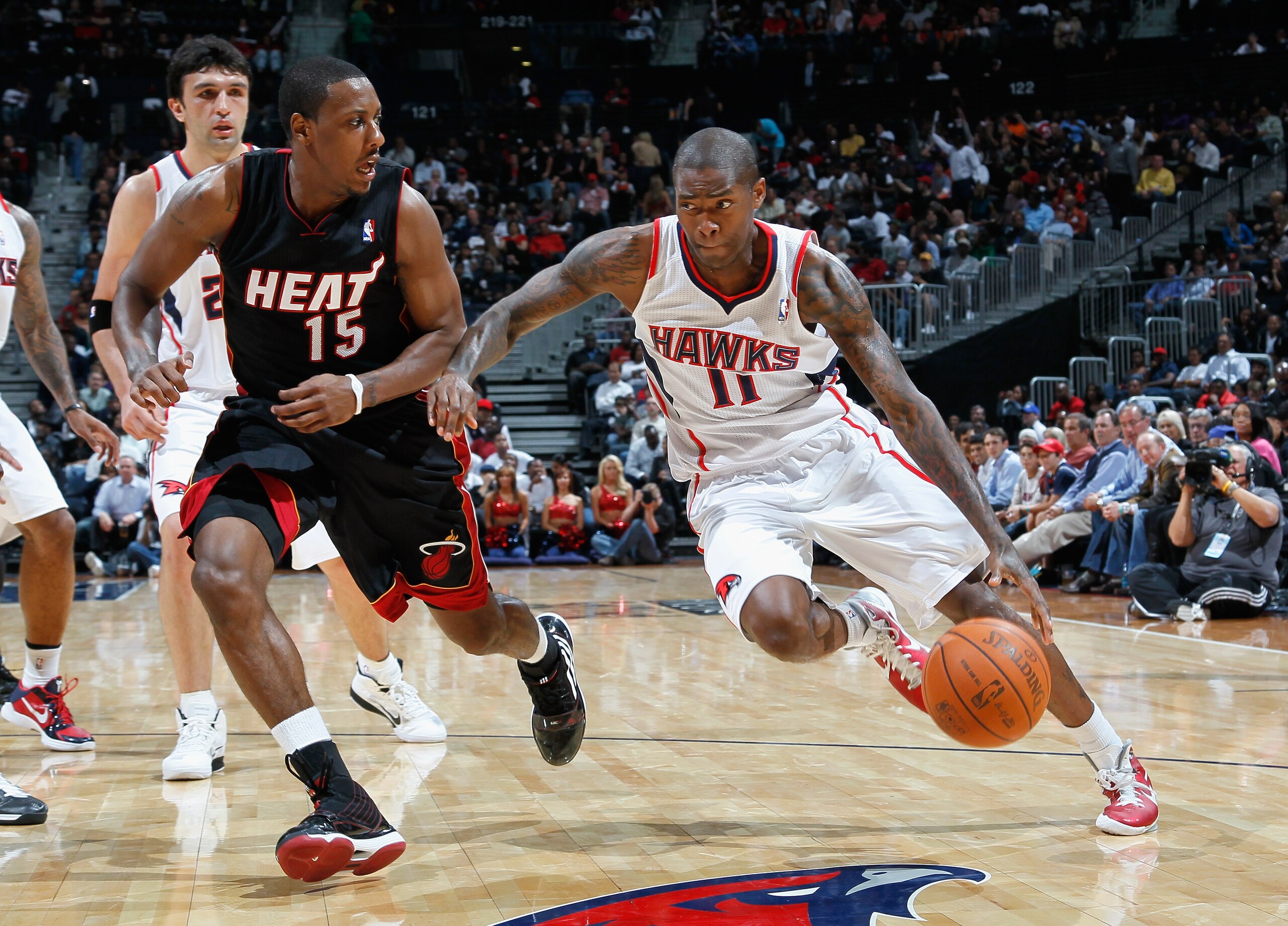 ATLANTA - OCTOBER 21:  Jamal Crawford #11 of the Atlanta Hawks against Mario Chalmers #15 of the Miami Heat at Philips Arena on October 21, 2010 in Atlanta, Georgia.  (Photo by Kevin C. Cox/Getty Images)