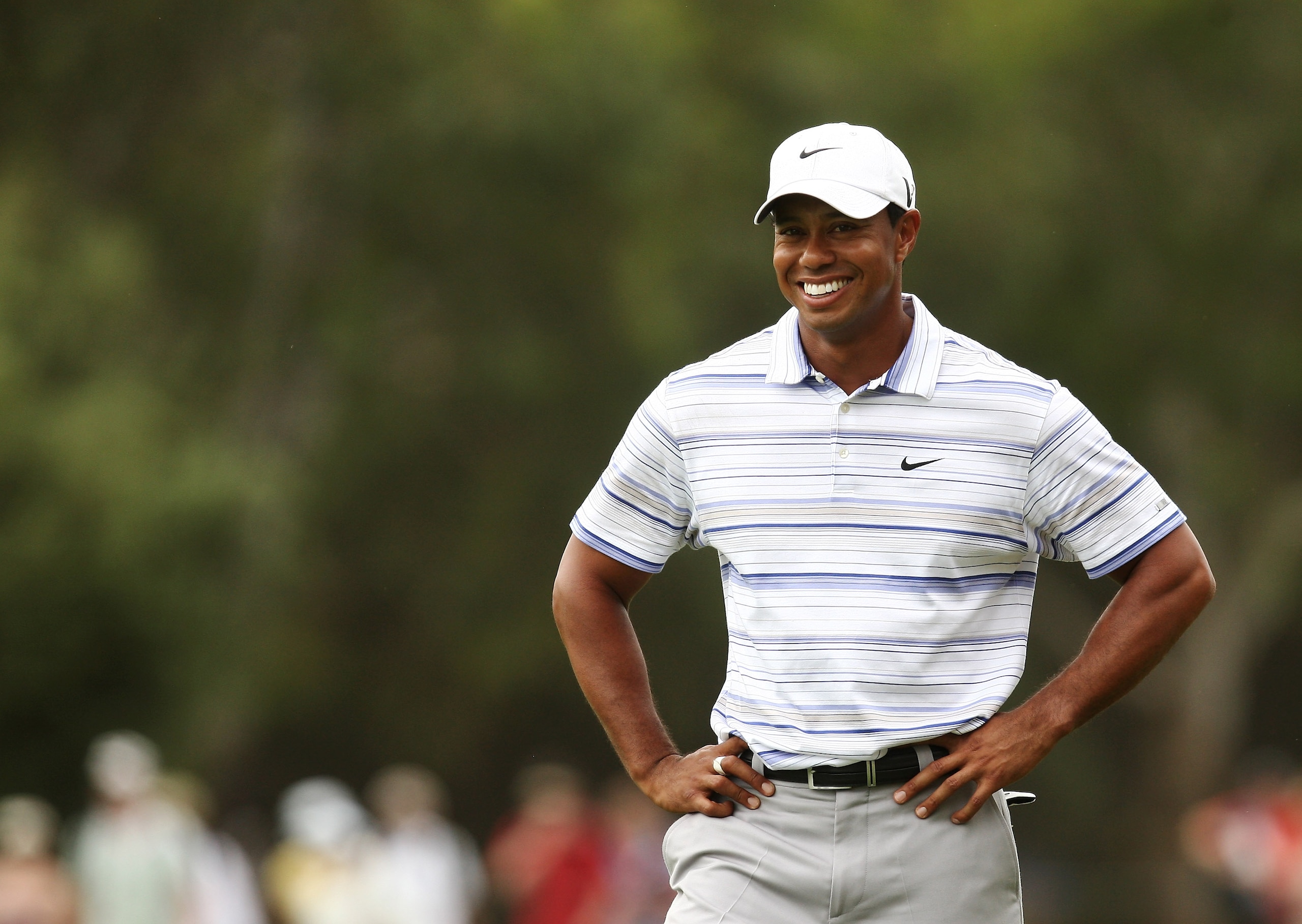 MELBOURNE, AUSTRALIA - NOVEMBER 14:  Tiger Woods of the USA smiles whilst preparing to play an approach on the 14th hole during round three of the 2009 Australian Masters at Kingston Heath Golf Club on November 14, 2009 in Melbourne, Australia.  (Photo by