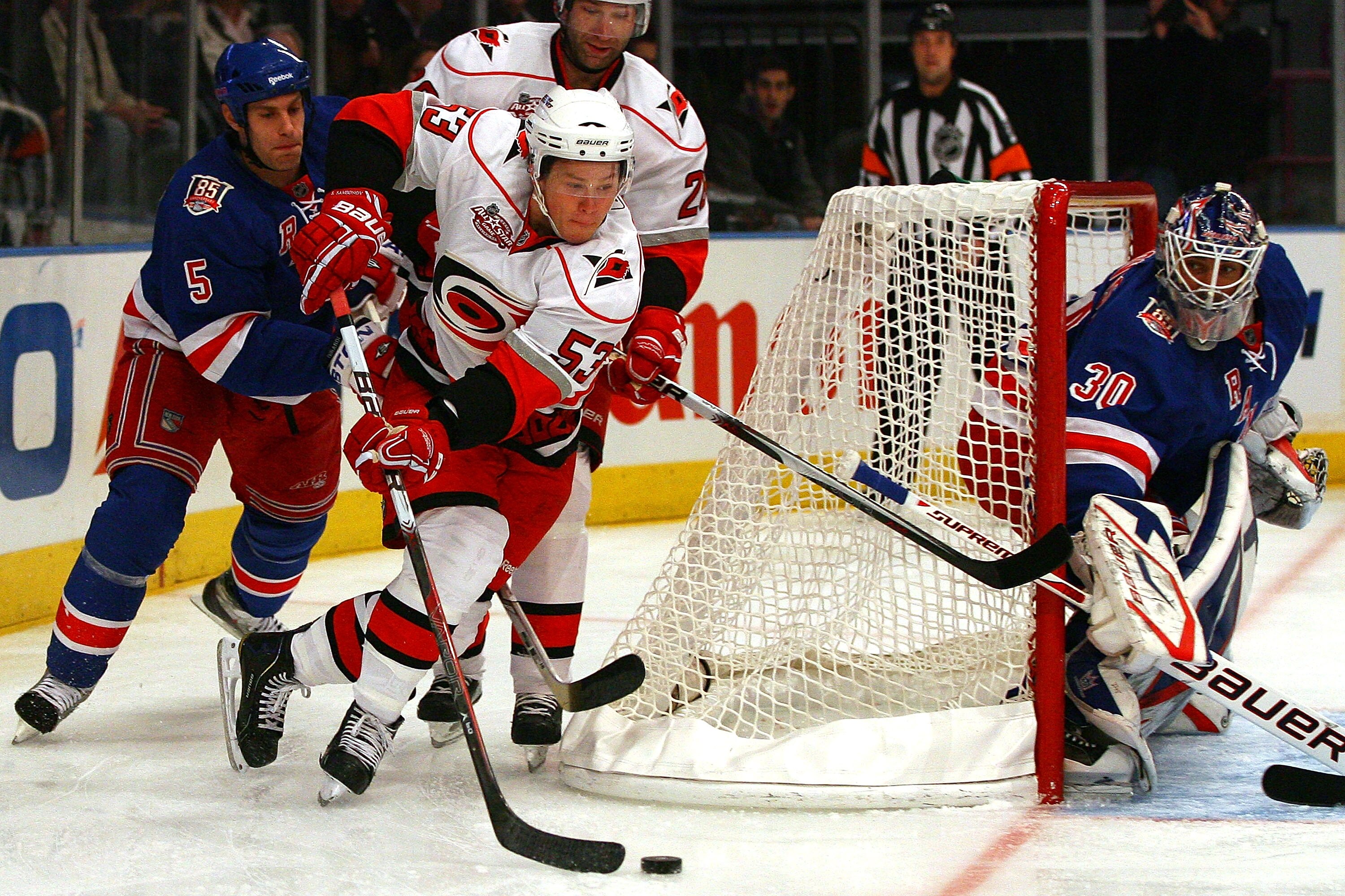 NEW YORK - OCTOBER 29:  Jeff Skinner #53 of the Carolina Hurricanes wraps around the goal to shoot while Dan Girardi #5 and Henrik Lundqvist #30 of the New York Rangers defend on October 29, 2010 at Madison Square Garden in New York City, New York.  The H