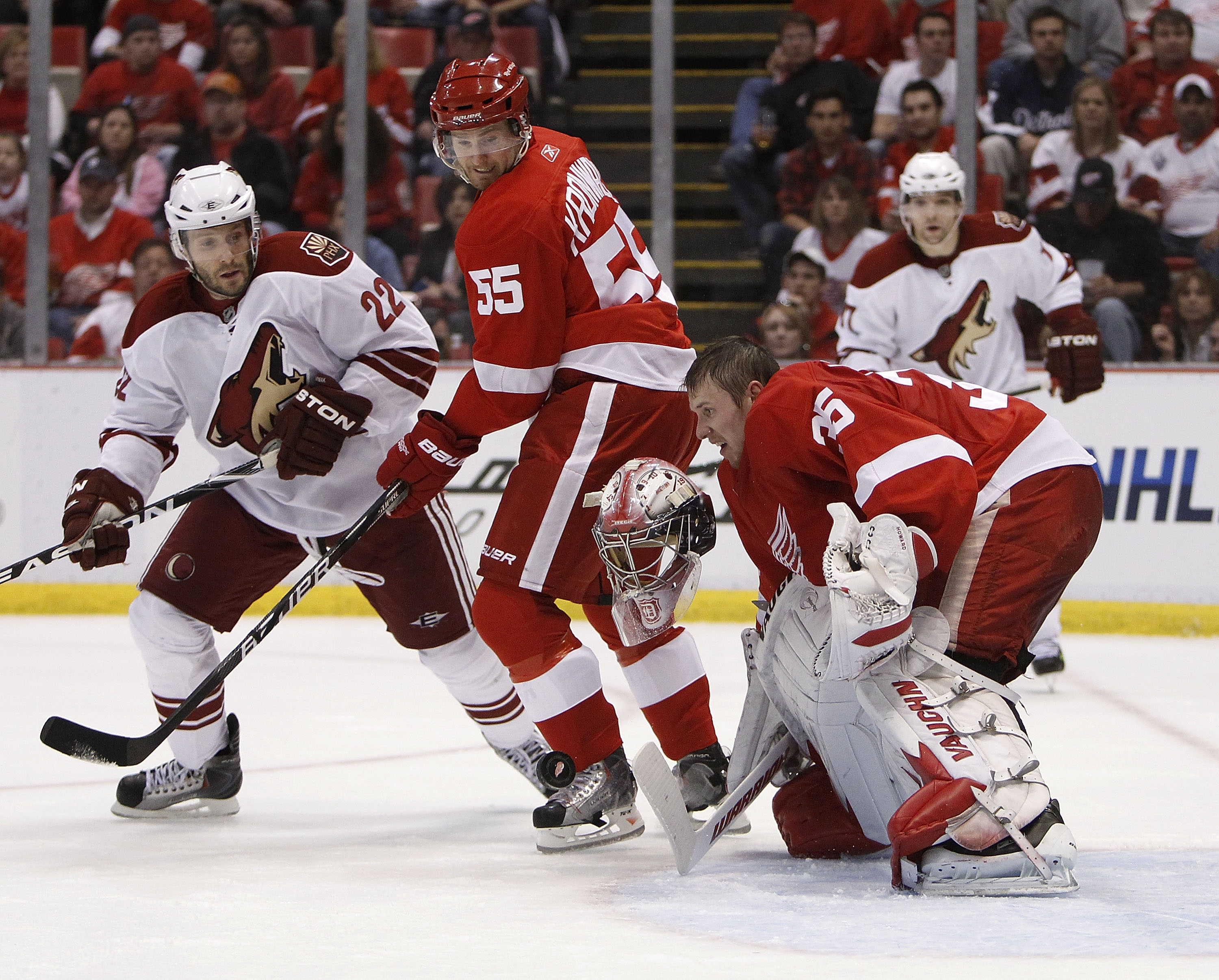 DETROIT - APRIL 20:  Jimmy Howard #35 of the Detroit Red Wings loses his mask making a save behind teammate Niklas Kronwall #55 and Lee Stempniak #22 of the Phoenix Coyotes during Game Four of the Western Conference Quarterfinals of the 2010 NHL Stanley C