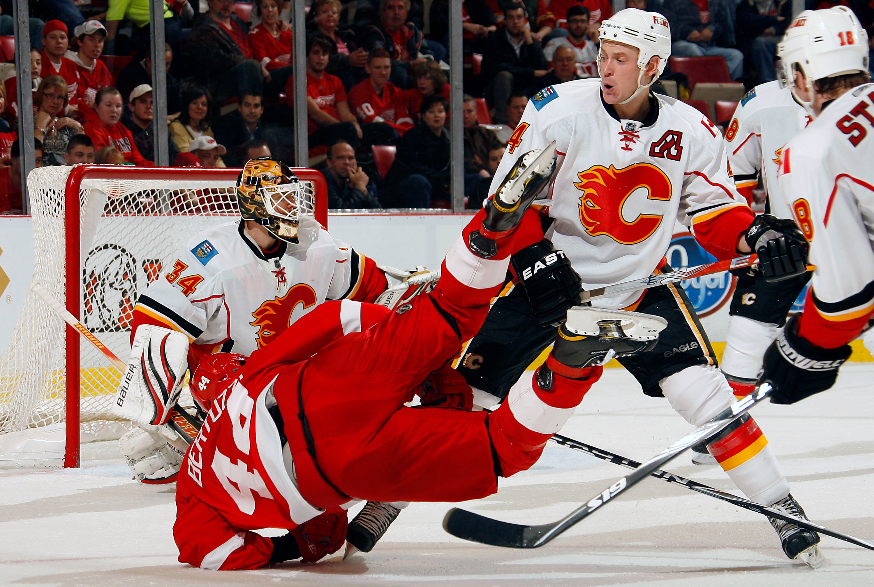 DETROIT - NOVEMBER 21:  Jay Bouwmeester #4 of the Calgary Flames checks Todd Bertuzzi #44 of the Detroit Red Wings during their NHL game at Joe Louis Arena on November 21, 2010 in Detroit, Michigan. (Photo By Dave Sandford/Getty Images)