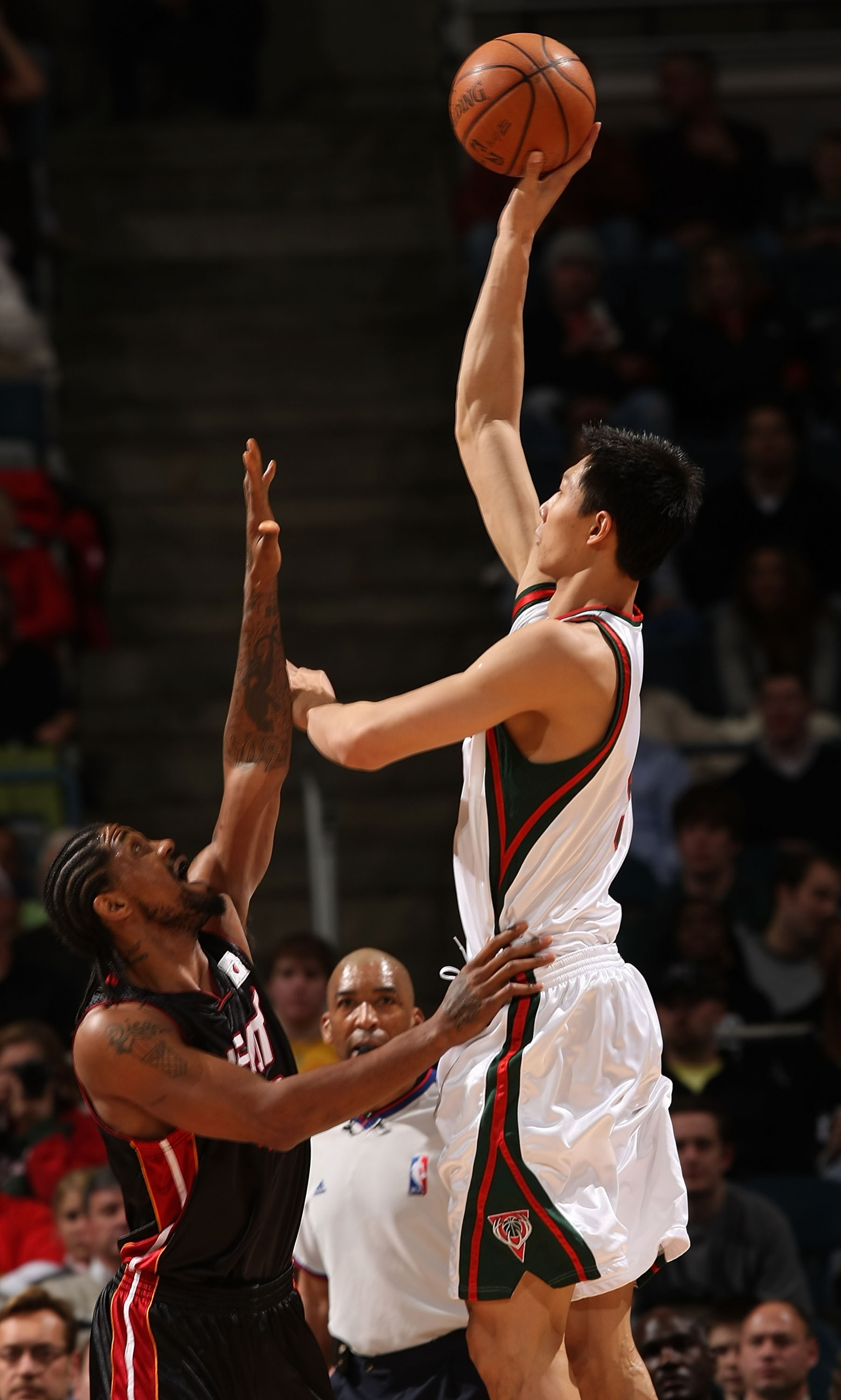 MILWAUKEE - JANUARY 09: Yi Jianlian #9 of the Milwaukee Bucks puts up a shot over Udonis Haslem #40 of the Miami Heat on January 9, 2008 at the Bradley Center in Milwaukee, Wisconsin.The Bucks defeated the Heat 98-92. NOTE TO USER: User expressly acknowle