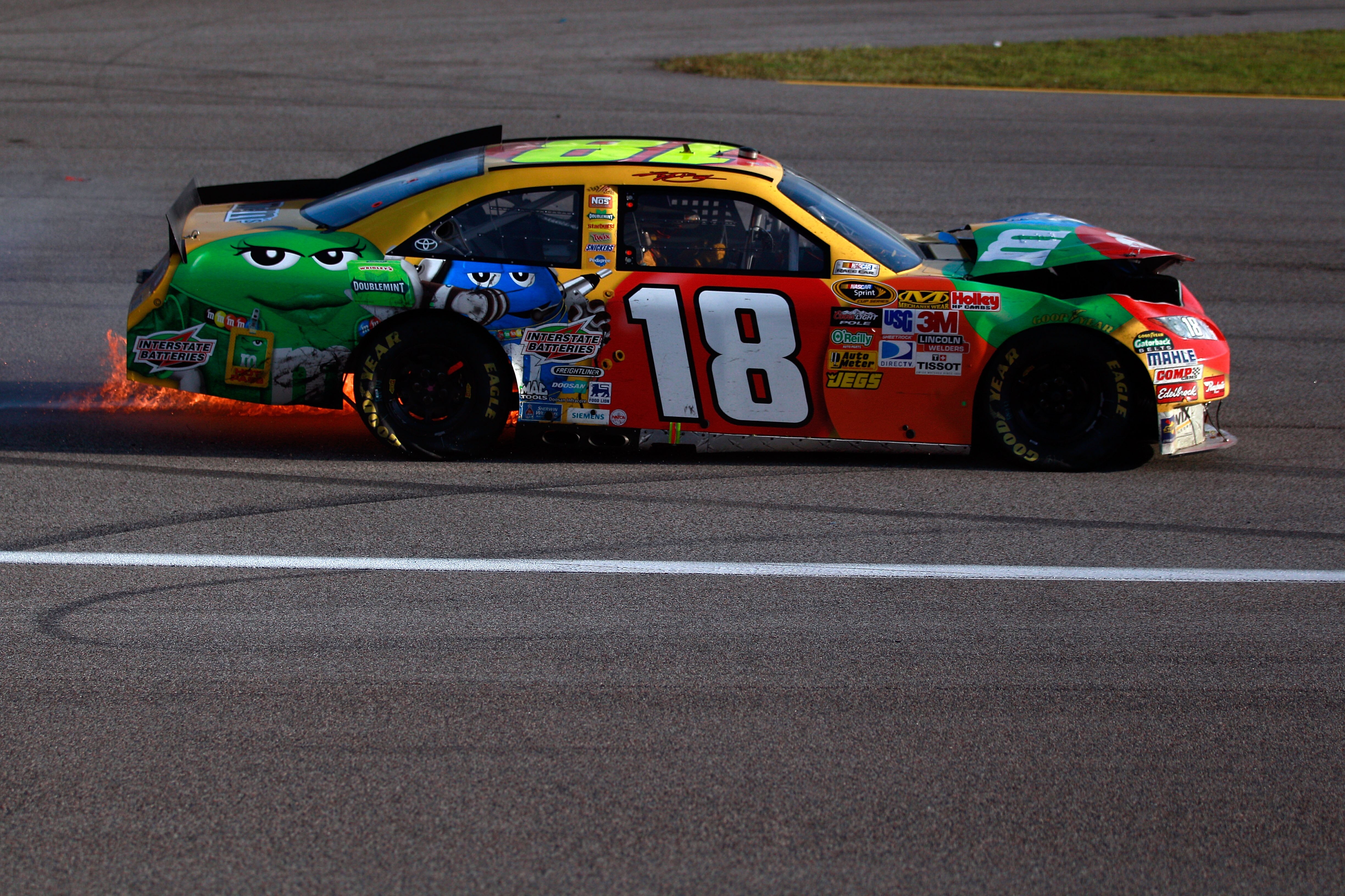 HOMESTEAD, FL - NOVEMBER 21:  Kyle Busch, driver of the #18 M&M'sToyota, drives with his car on fire after crashing during the NASCAR Sprint Cup Series Ford 400 at Homestead-Miami Speedway on November 21, 2010 in Homestead, Florida.  (Photo by Chris Grayt
