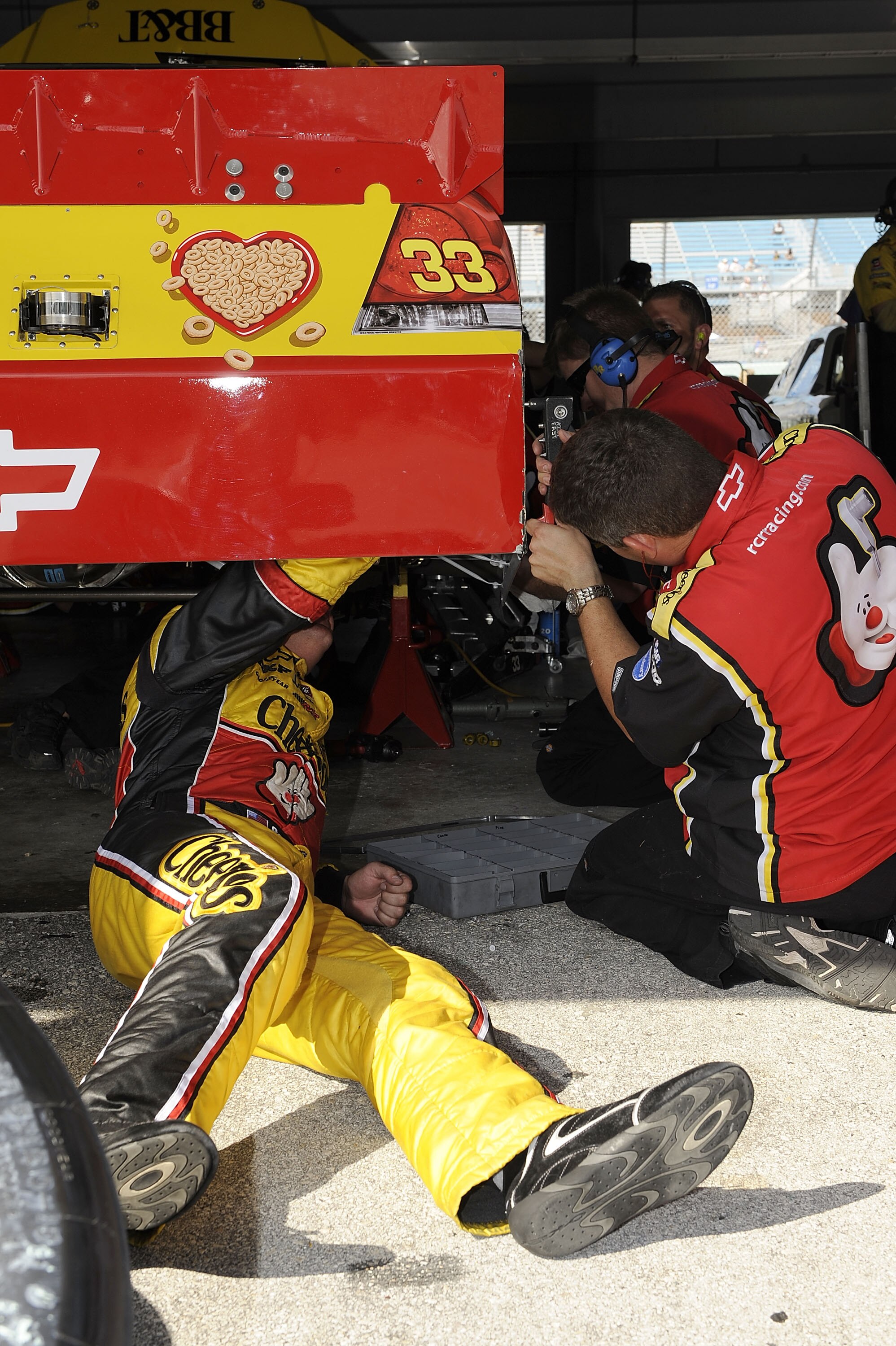 HOMESTEAD, FL - NOVEMBER 20:  Clint Bowyer (L), driver of the #33 Cheerios Chevrolet, works on his car with a crew member during practice for the NASCAR Sprint Cup Series Ford 400 at Homestead-Miami Speedway on November 20, 2010 in Homestead, Florida.  (P