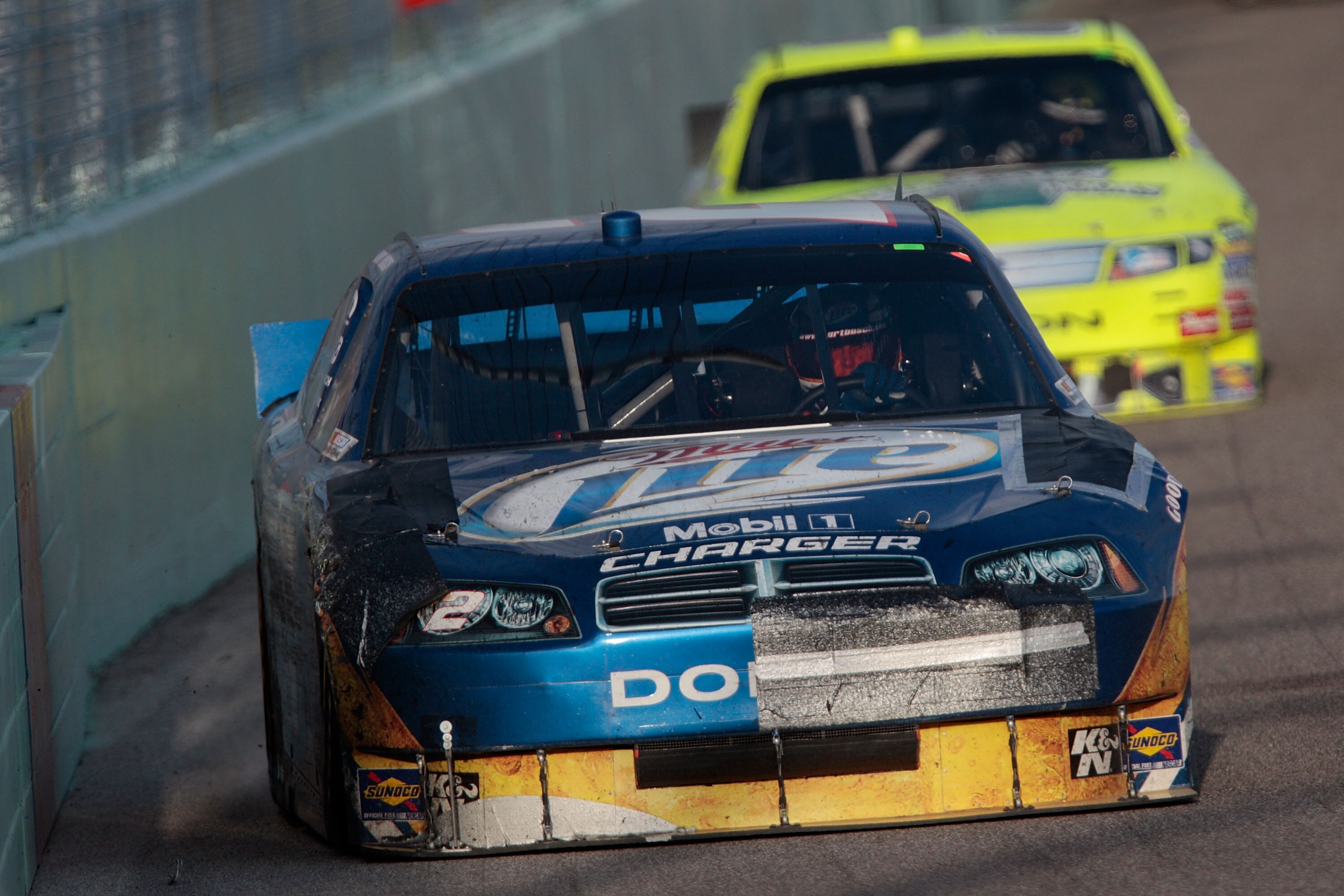 HOMESTEAD, FL - NOVEMBER 21:  Kurt Busch, driver of the #2 Miller Lite Dodge, drives with damage to his car after an accident during the NASCAR Sprint Cup Series Ford 400 at Homestead-Miami Speedway on November 21, 2010 in Homestead, Florida.  (Photo by C