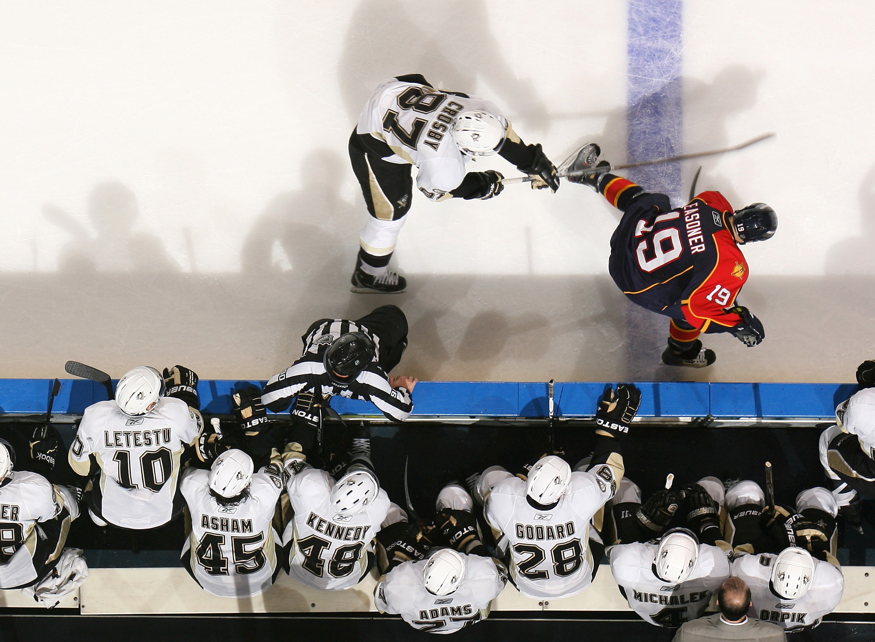 SUNRISE, FL - NOVEMBER 22: Sidney Crosby #87 of the Pittsburgh Penguins checks Marty Reasoner #19 of the Florida Panthers as he skates in front of the Penguins bench on November 22, 2010 at the BankAtlantic Center in Sunrise, Florida. The Penguins defeate