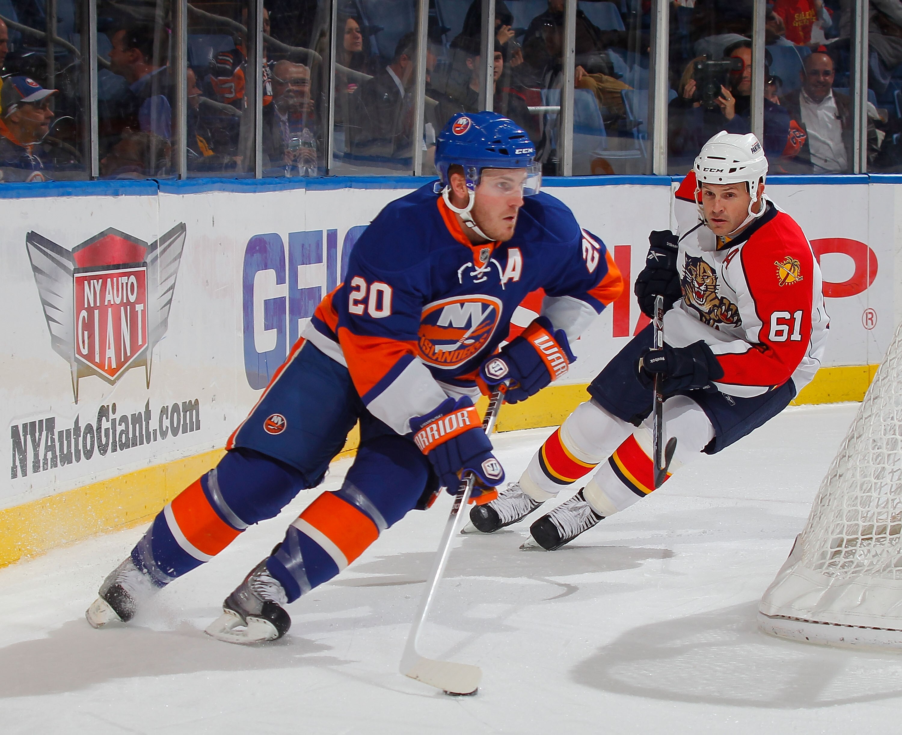 UNIONDALE, NY - NOVEMBER 20:  James Wisniewski #20 of the New York Islanders skates during a hockey game against the Florida Panthers as Cory Stillman #61 of the Panthers follows at the Nassau Coliseum on November 20, 2010 in Uniondale, New York.  (Photo