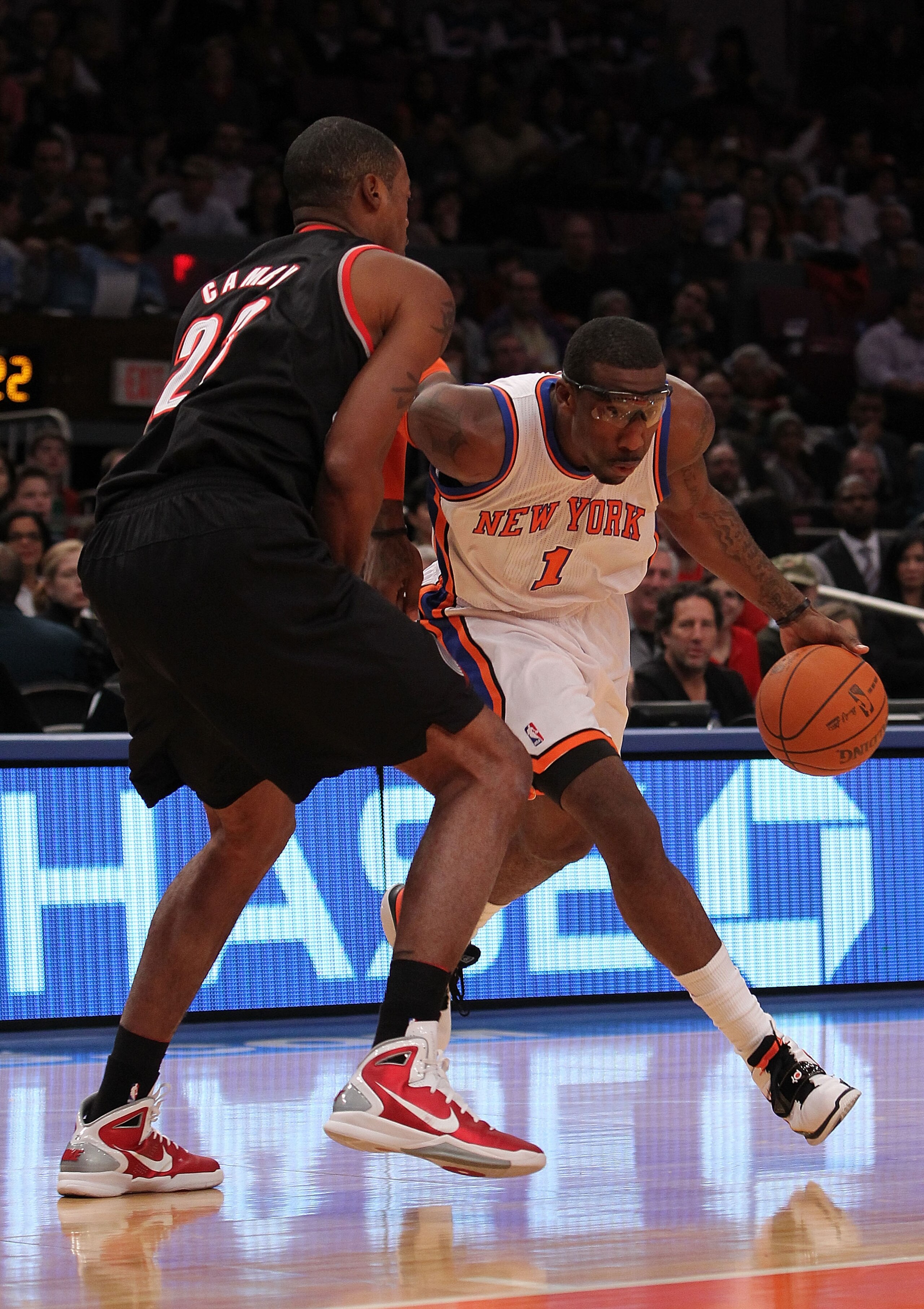 NEW YORK - OCTOBER 30:  Amar'e Stoudemire #1 of the New York Knicks drives against Marcus Camby #23 of the Portland Trail Blazers at Madison Square Garden on October 30, 2010 in New York City. NOTE TO USER: User expressly acknowledges and agrees that, by