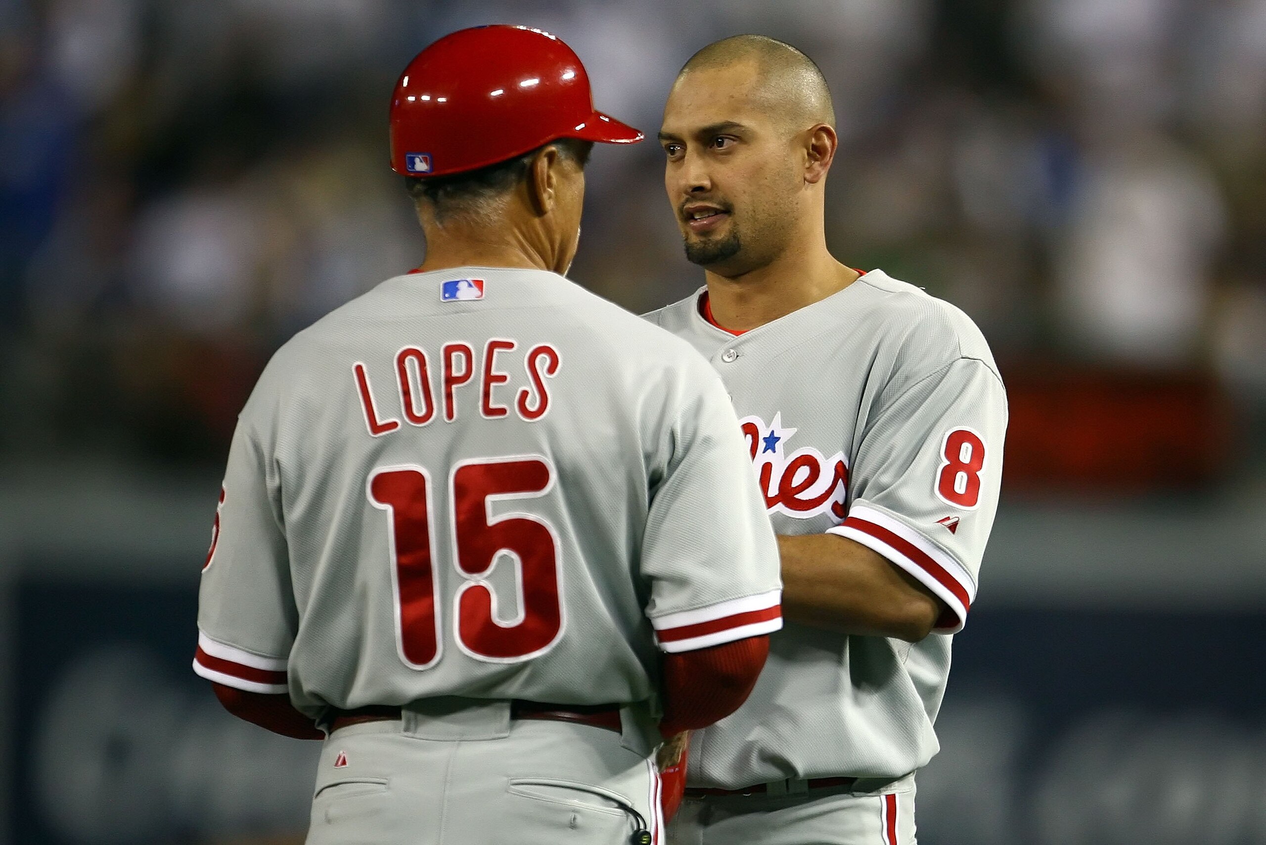 LOS ANGELES, CA - OCTOBER 12:  Shane Victorino #8 of the Philadelphia Phillies talks with first base coach Davey Lopes while taking on the Los Angeles Dodgers in Game Three of the National League Championship Series during the 2008 MLB playoffs on October