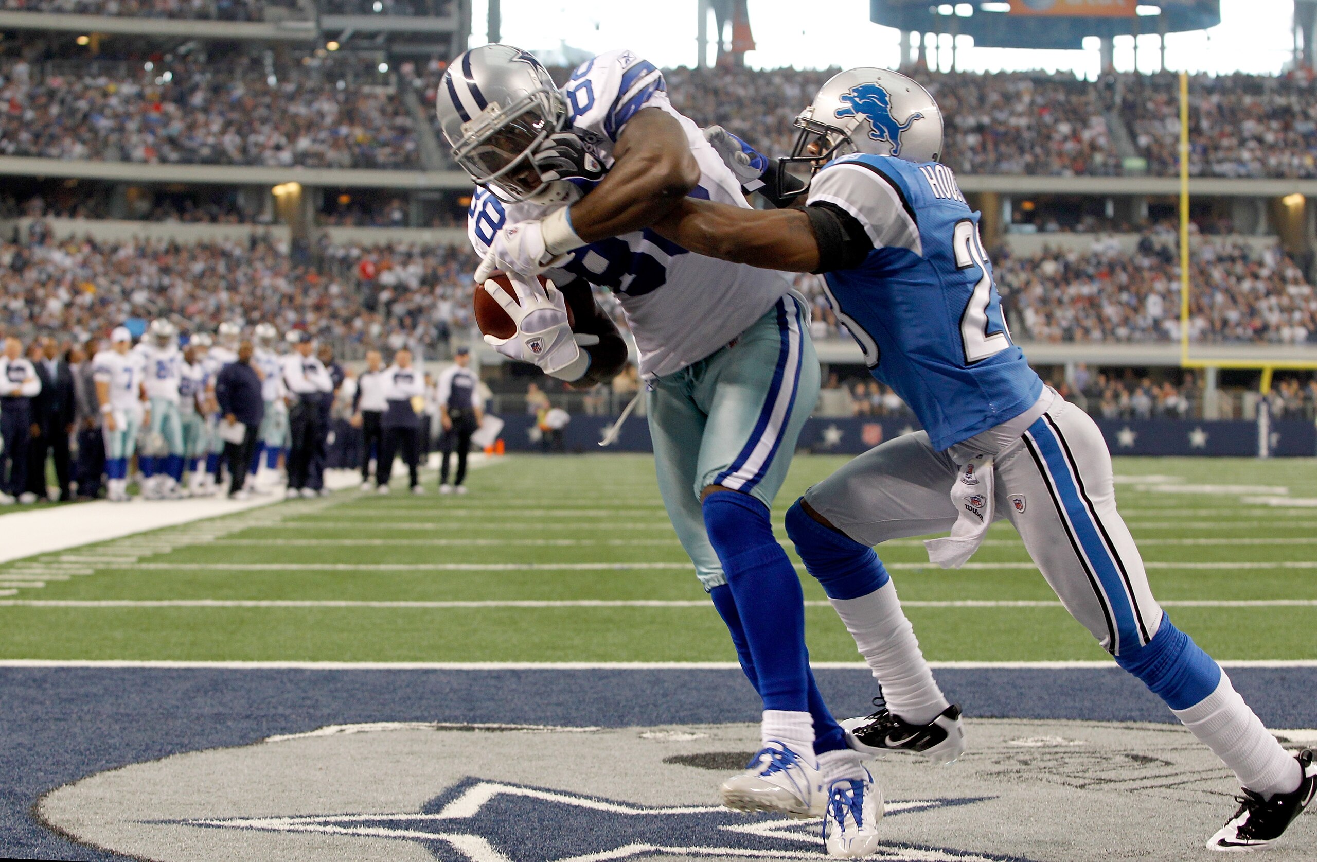 ARLINGTON, TX - NOVEMBER 21:  Dez Bryant #88 of the Dallas Cowboys scores against Chris Houston #23 of the Detroit Lions at Cowboys Stadium on November 21, 2010 in Arlington, Texas.  (Photo by Tom Pennington/Getty Images)
