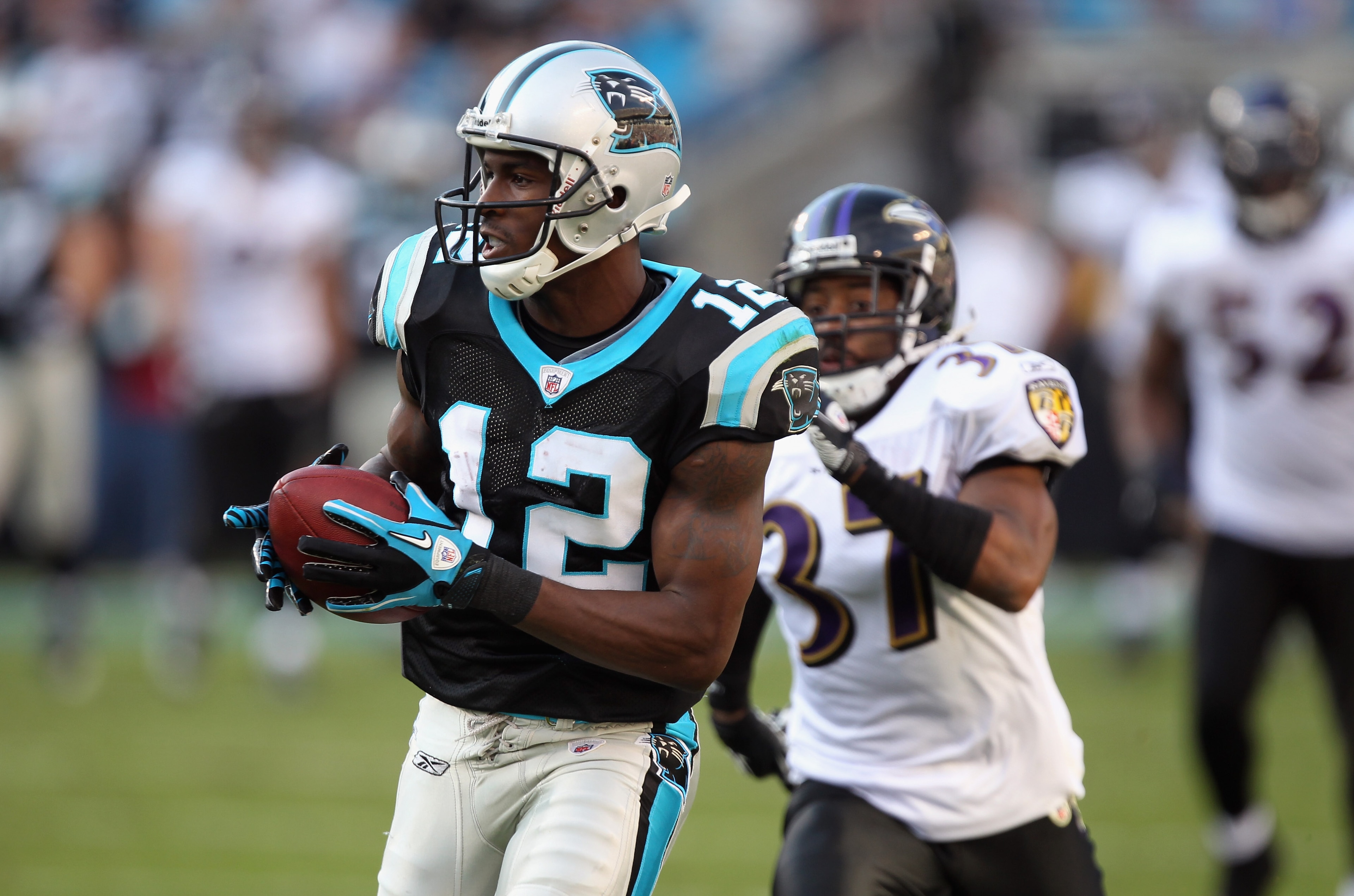 CHARLOTTE, NC - NOVEMBER 21:  Josh Wilson #37 of the Baltimore Ravens watches as David Gettis #12 of the Carolina Panthers catches a touchdown pass at Bank of America Stadium on November 21, 2010 in Charlotte, North Carolina.  (Photo by Streeter Lecka/Get