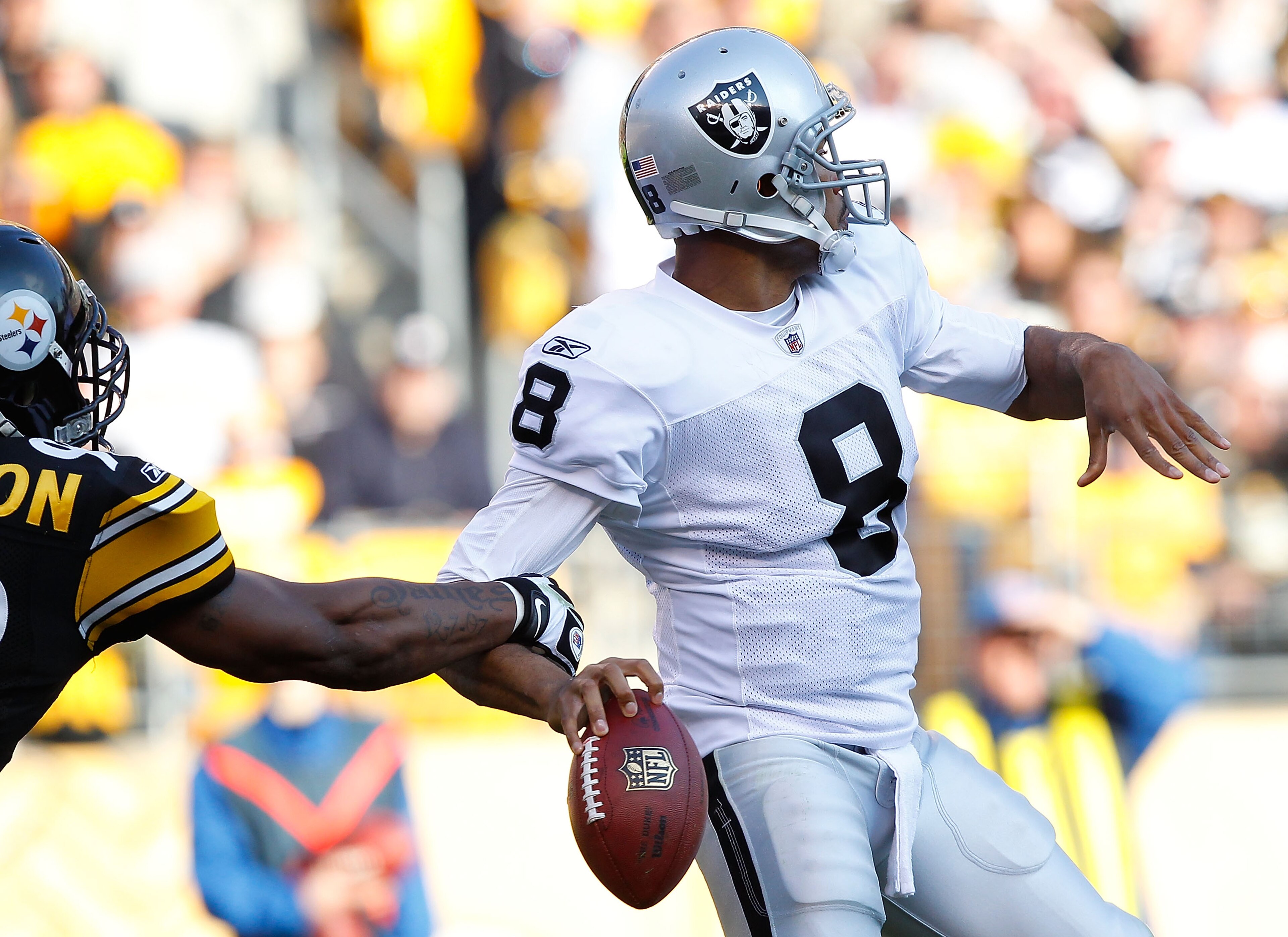 PITTSBURGH - NOVEMBER 21:  Jason Campbell #8 of the Oakland Raiders has the ball stripped from his hand by James Harrison #92 of the Pittsburgh Steelers during the game on November 21, 2010 at Heinz Field in Pittsburgh, Pennsylvania.  (Photo by Jared Wick