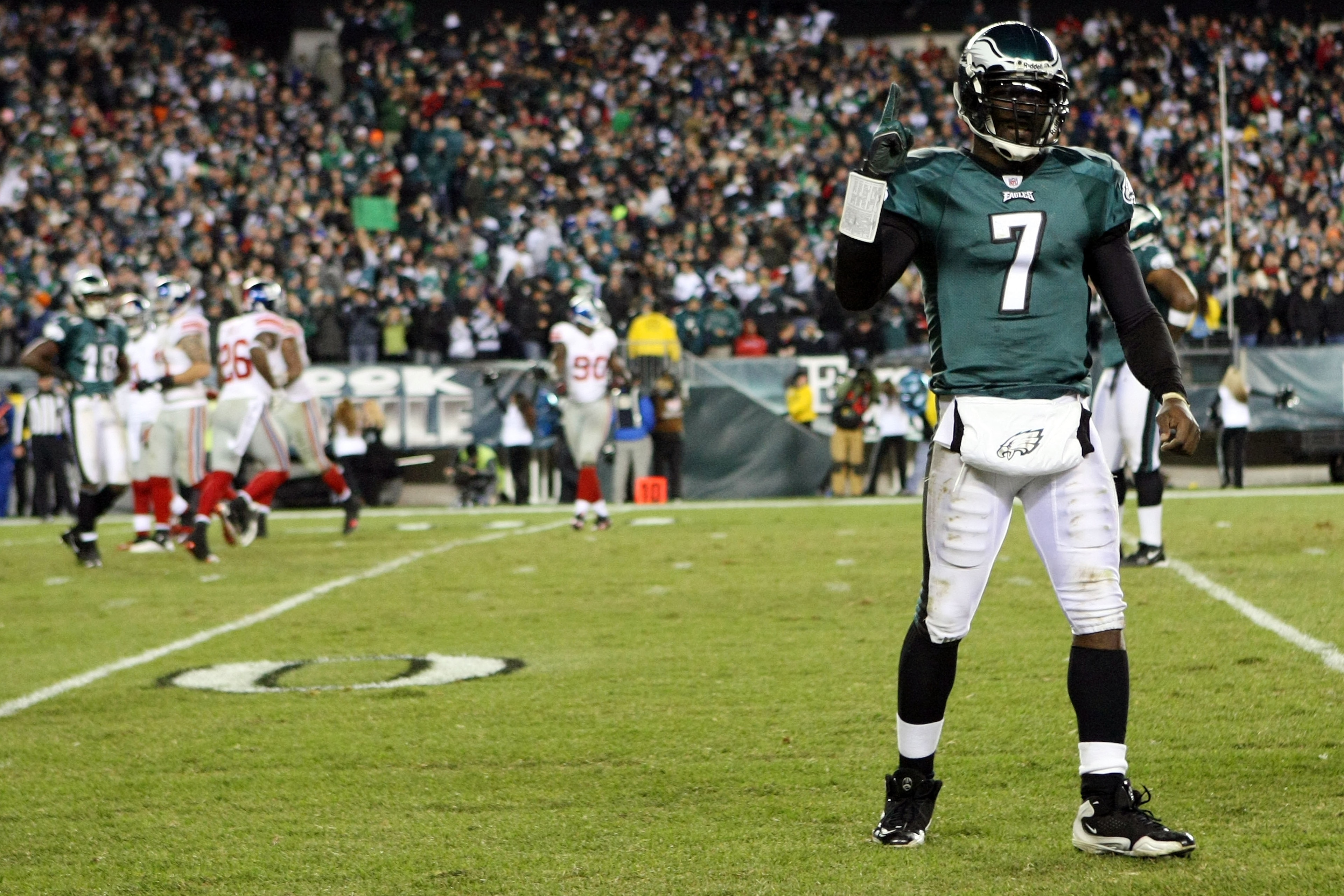 PHILADELPHIA - NOVEMBER 21:  Michael Vick #7 of the Philadelphia Eagles celebrates after converting on a two point conversion in the fourth quarter as Justin Tuck #91 of the New York Giants looks on at Lincoln Financial Field on November 21, 2010 in Phila