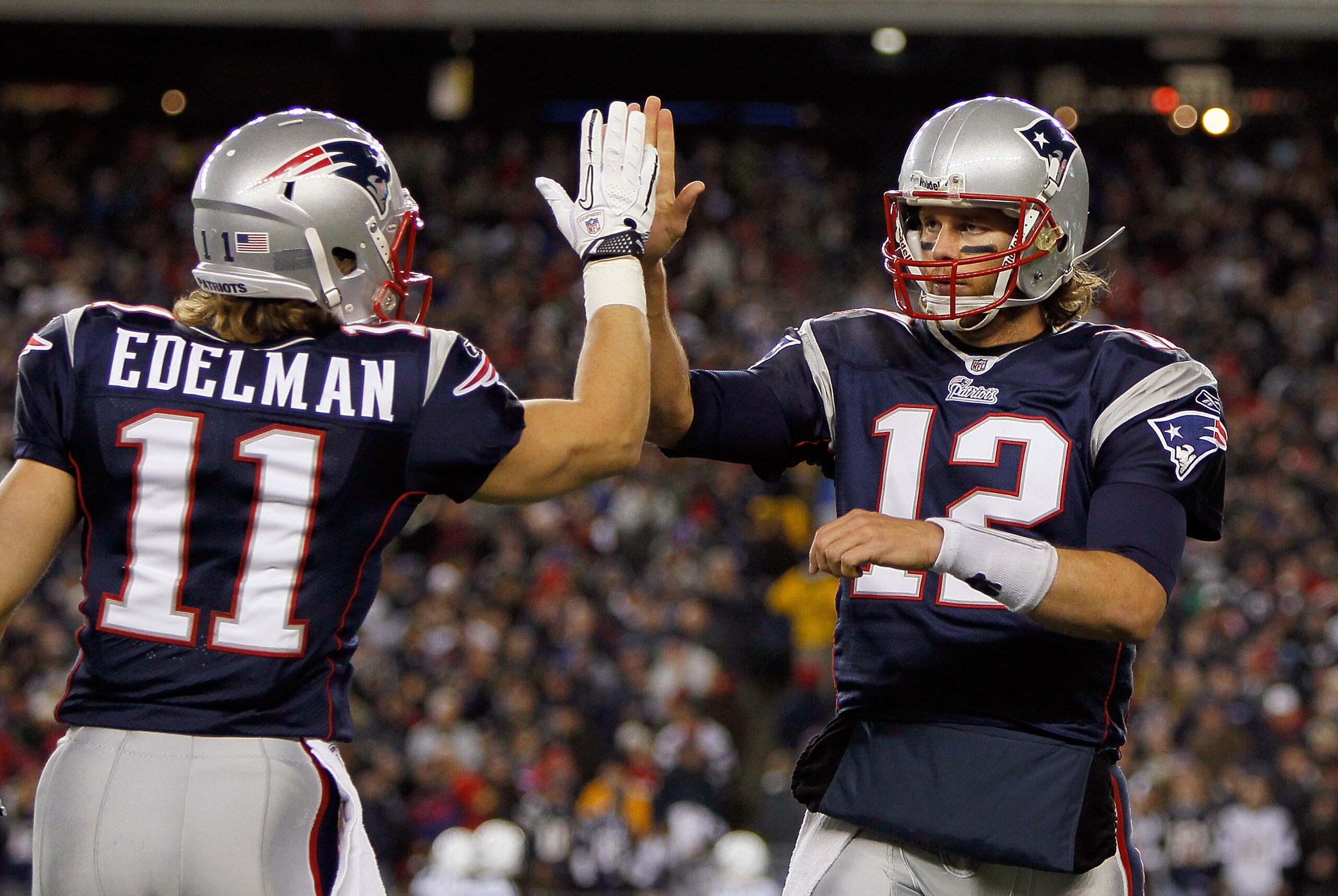 FOXBORO, MA - NOVEMBER 21: Tom Brady #12 of the New England Patriots reacts with teammate Julian Edelman #11 after a touchdown in the second half at Gillette Stadium on November 21, 2010 in Foxboro, Massachusetts. (Photo by Jim Rogash/Getty Images)